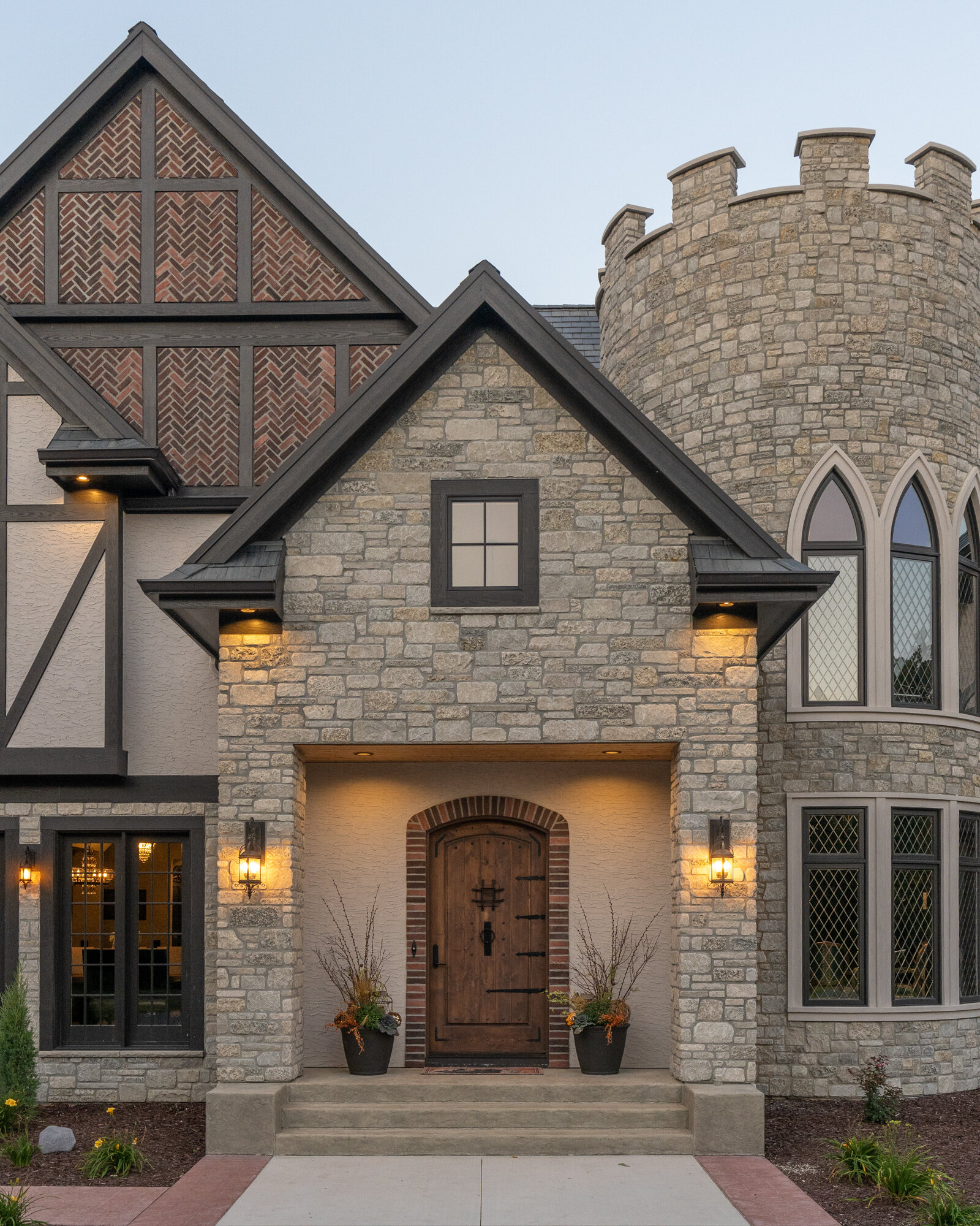 Evening photograph of a stone exterior with turret in Minnesota
