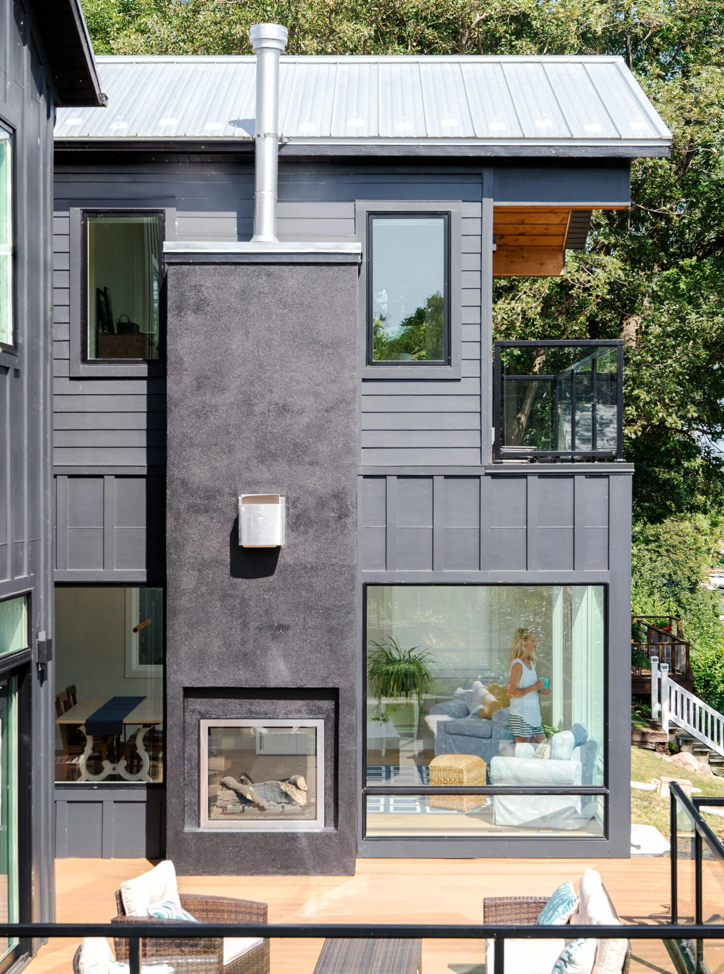 Young model standing in modern living room of a lake home