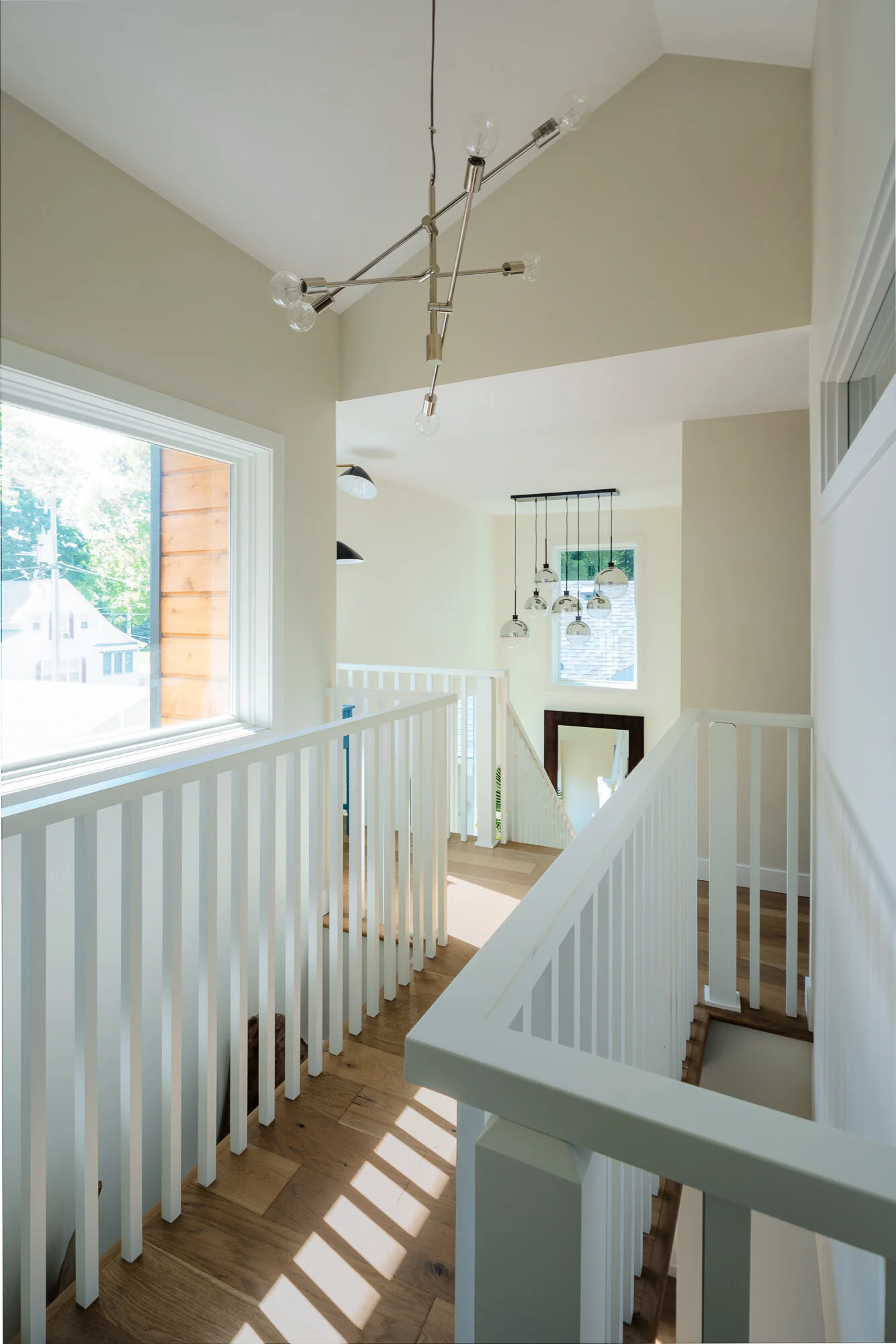 A bridge connects the upper level of this modern lake home.