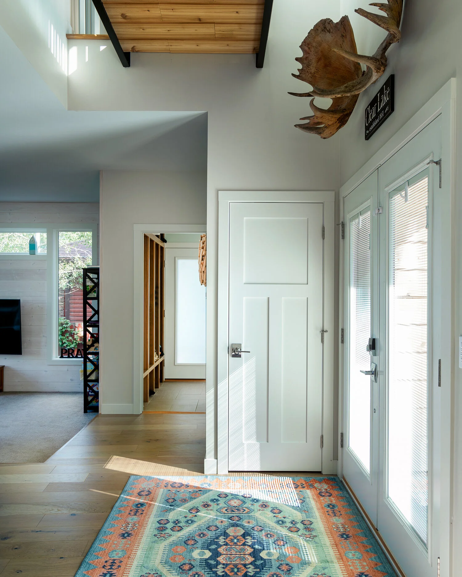 Stunning entryway for modern lake home with beautiful area rug