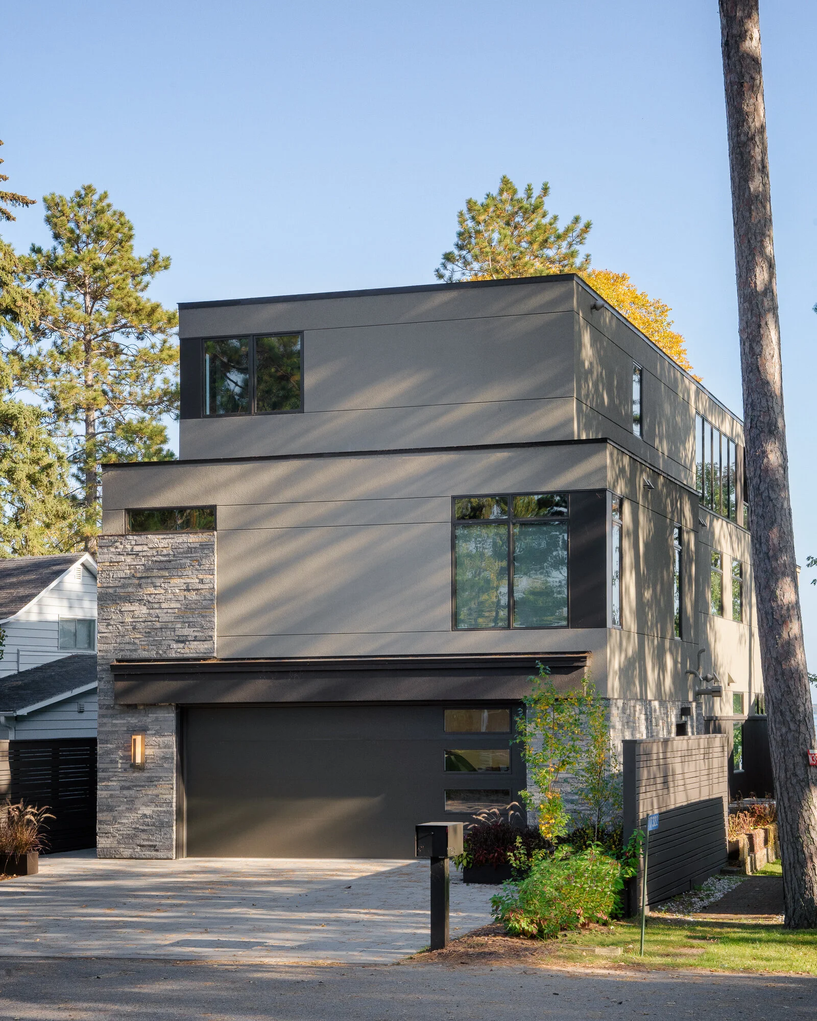 Residential architectural photograph of beautiful light and shadows across this modern lake home in Northern Minnesota