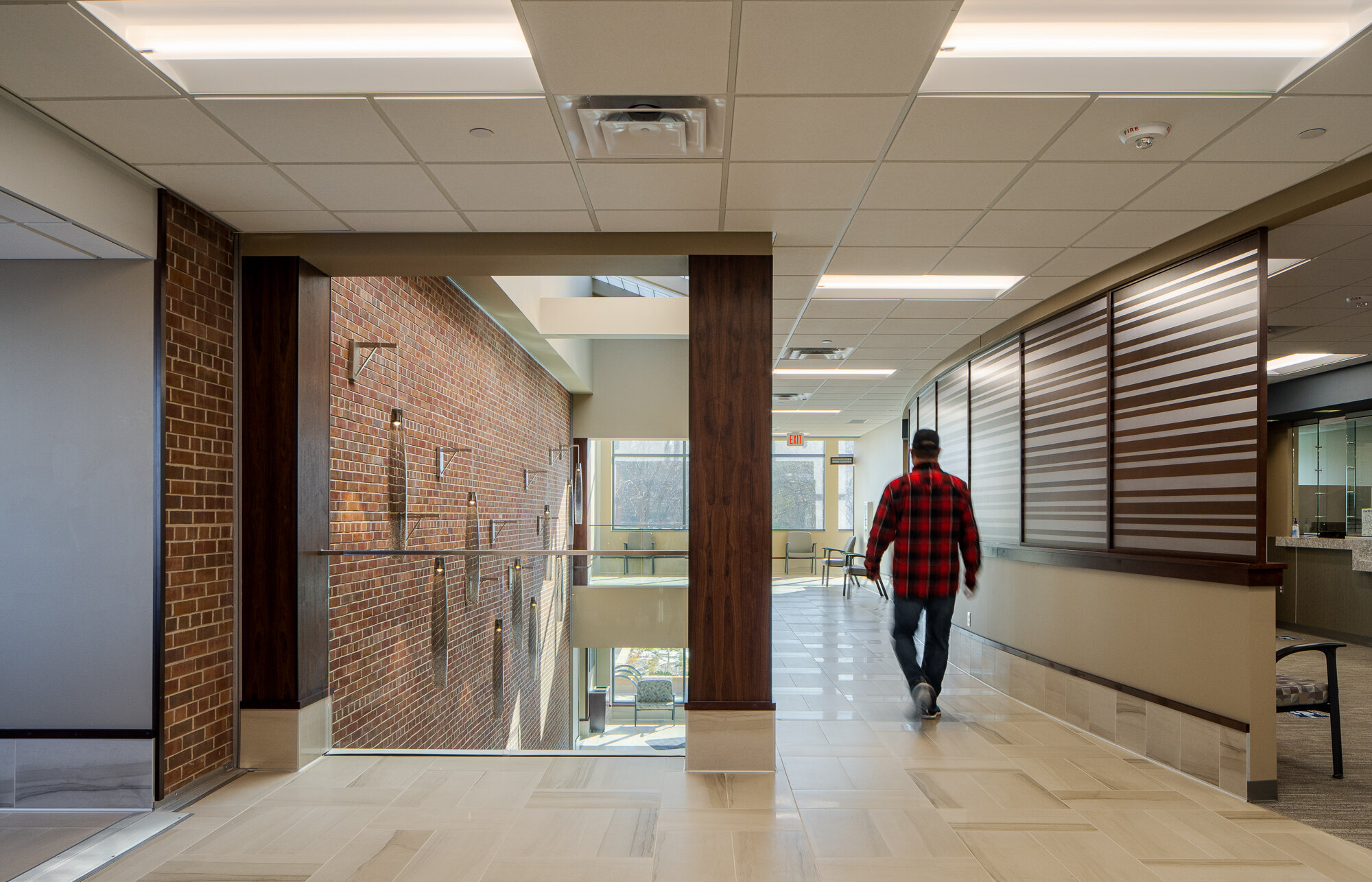 A man walks through a well-lit hallway of the blue earth county government center in mankato minnesota