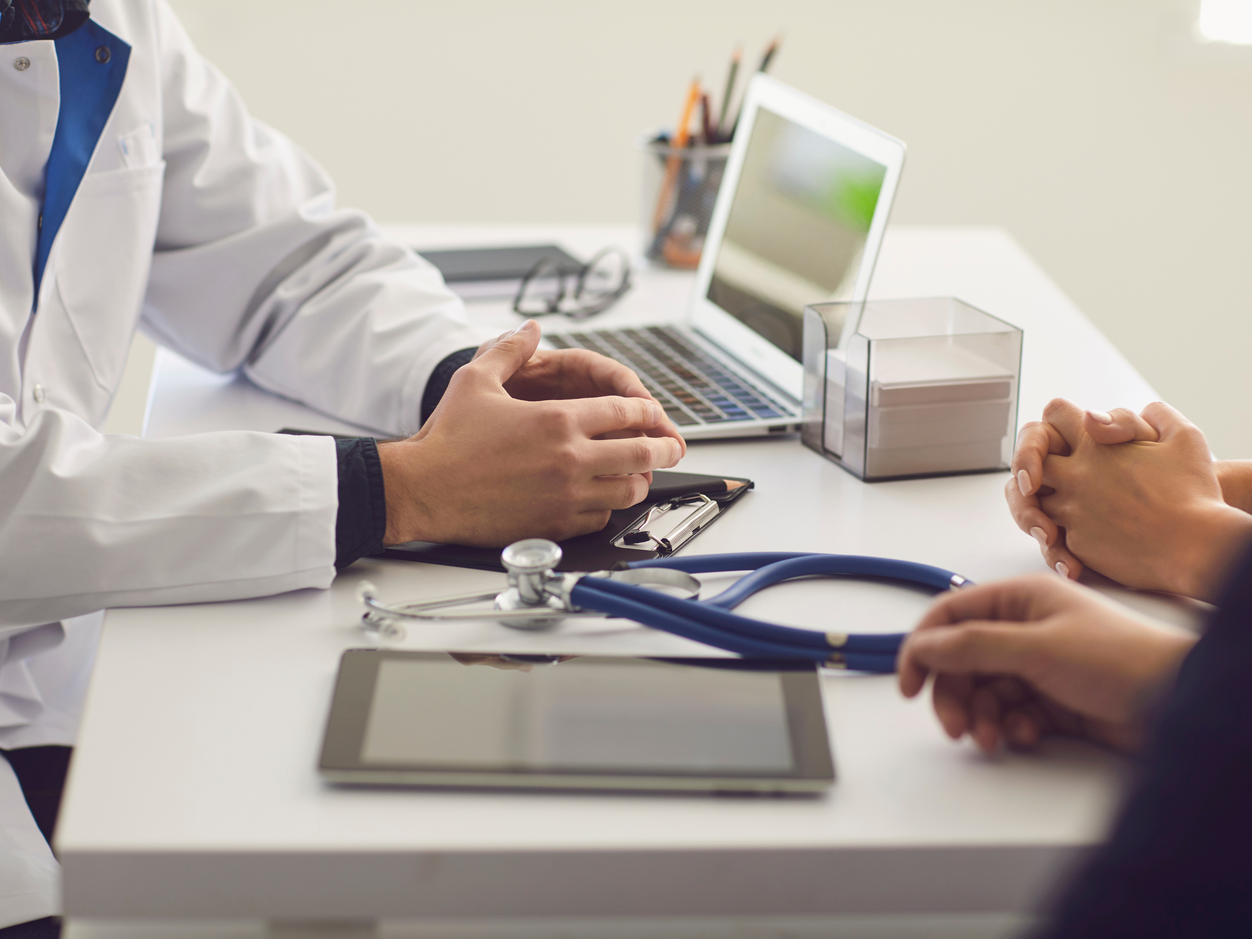 Medical staff sitting down with patient