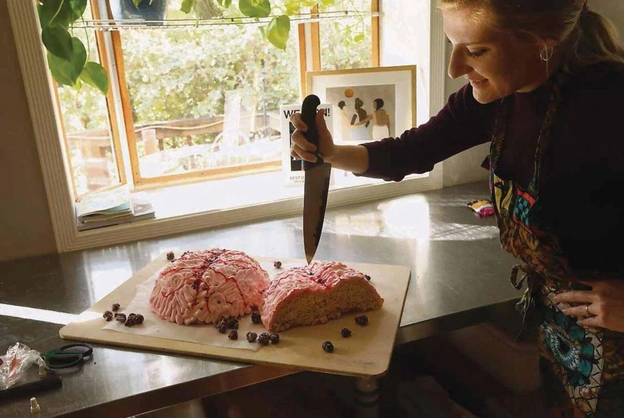 Baker preparing a brain-shaped cake for Brains and Baking.