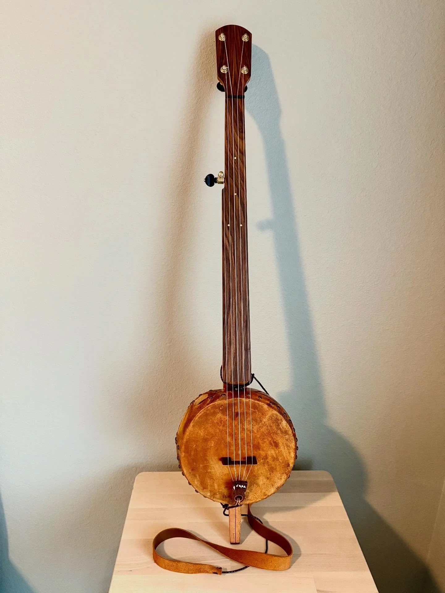 We are called this #8. Cherry neck, morado fingerboard and peghead overlay. I tried an experiment in stabilizing the gourd material, and it paid off, I think, in making things sound a bit brighter and strengthening the fruit.  I&rsquo;m on my way to 