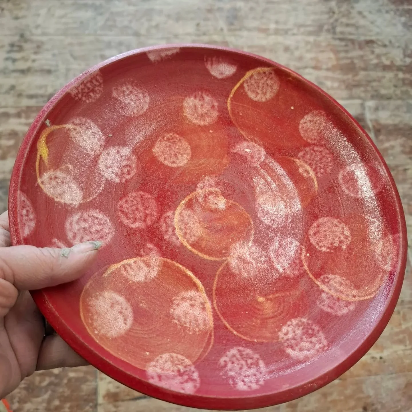 Plates decorated with engobes.

What is an engobe? 
It's a kind of a coloured slip, underglaze, and glaze to put it simply. 

We have 10 engobes that we make in the studio. They can be used on greenware or bisqueware. Its always good to test them fir
