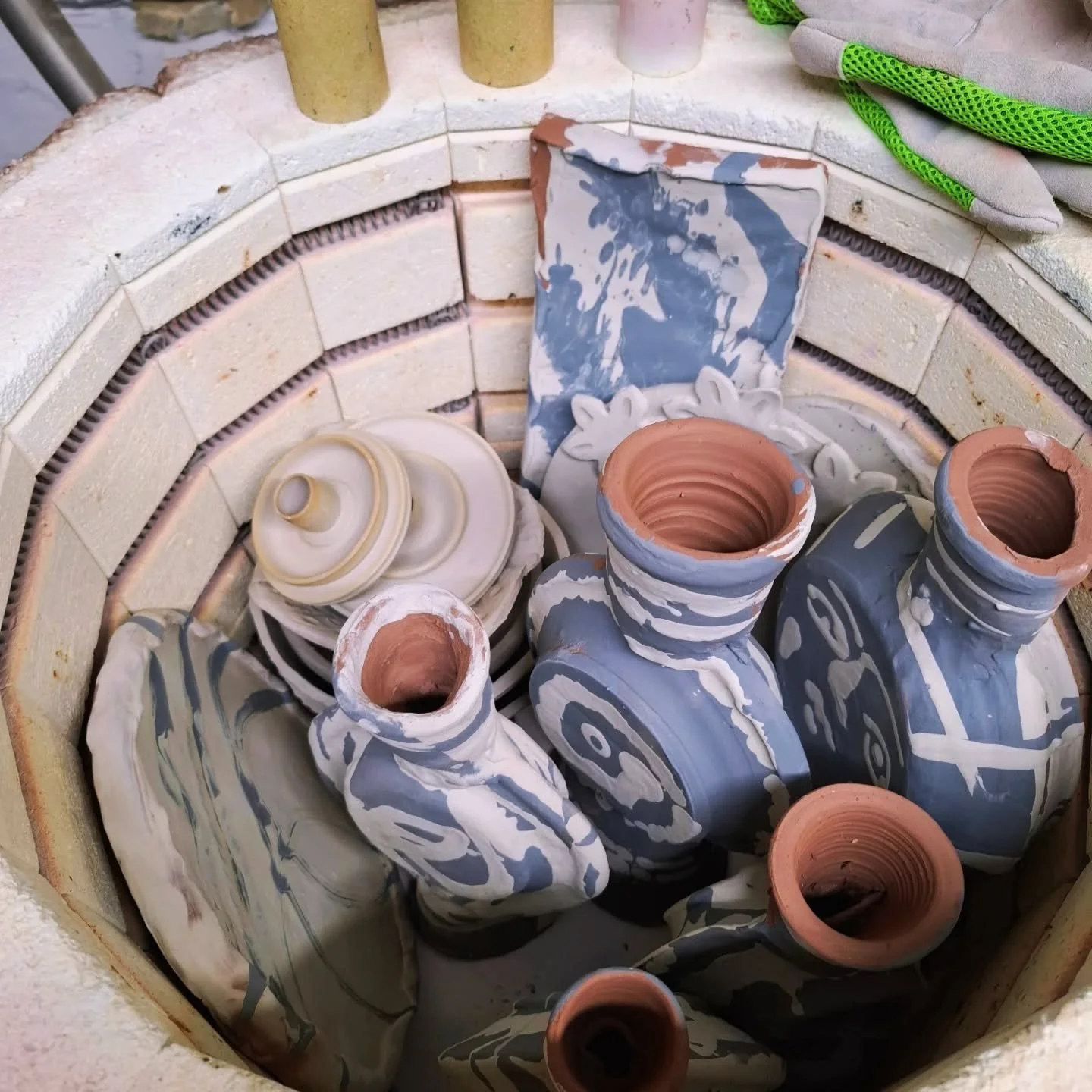Two fully packed kilns ready for the first firing, called a bisque fire, 1000 degrees. 

In this firing, everything can touch, be stacked inside each other, and large plates are put on their sides to maximise space and prevent warping. 
We aim to red