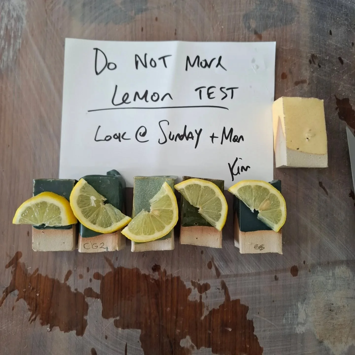 We have some new glaze test tiles, but they contain a high amount of copper. A simple test to see if they are leaching is letting a slice of lemon sit on them for a couple of days. 
Although its not a full proof scientific result, it does give us an 