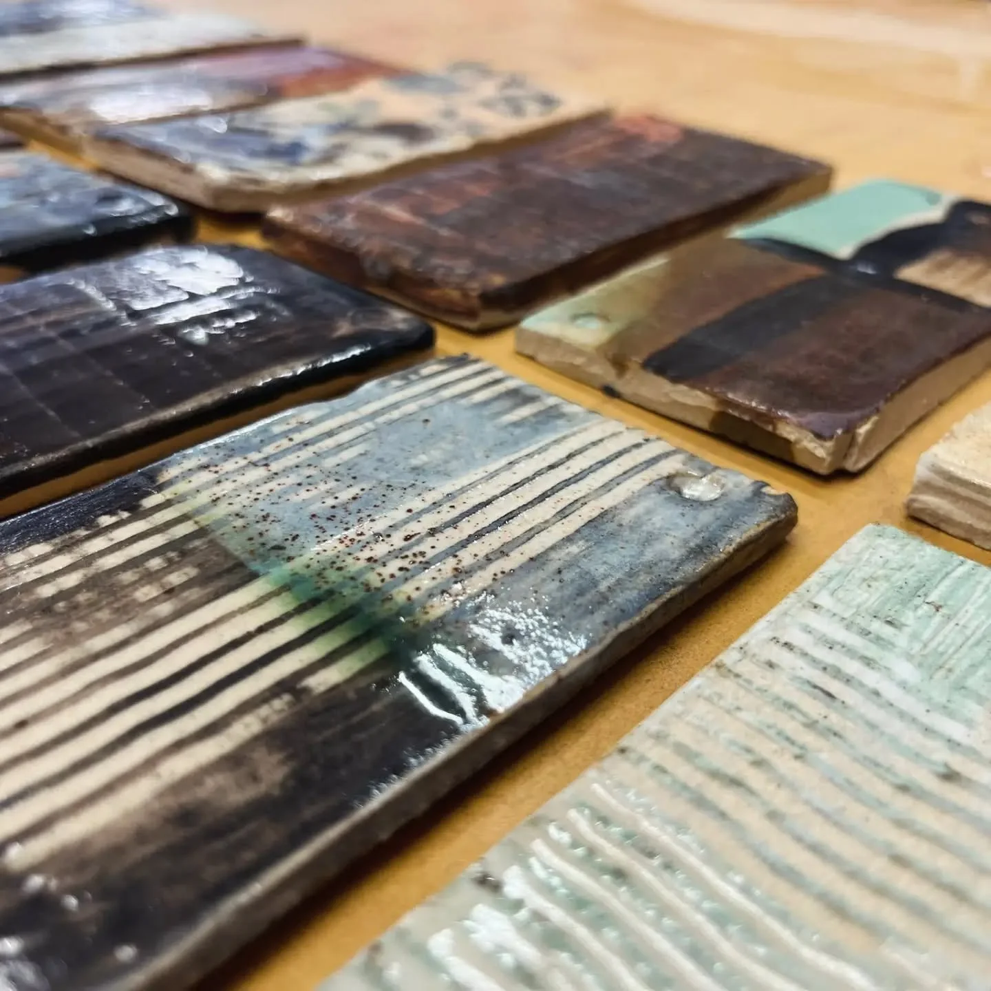 Glaze test tiles by one the students. There are so many combinations using overlapping slips, oxides and glazes so we encourage everyone to make test tiles as they progress with their making. 
It may be time consuming but it's fun and worth the time.