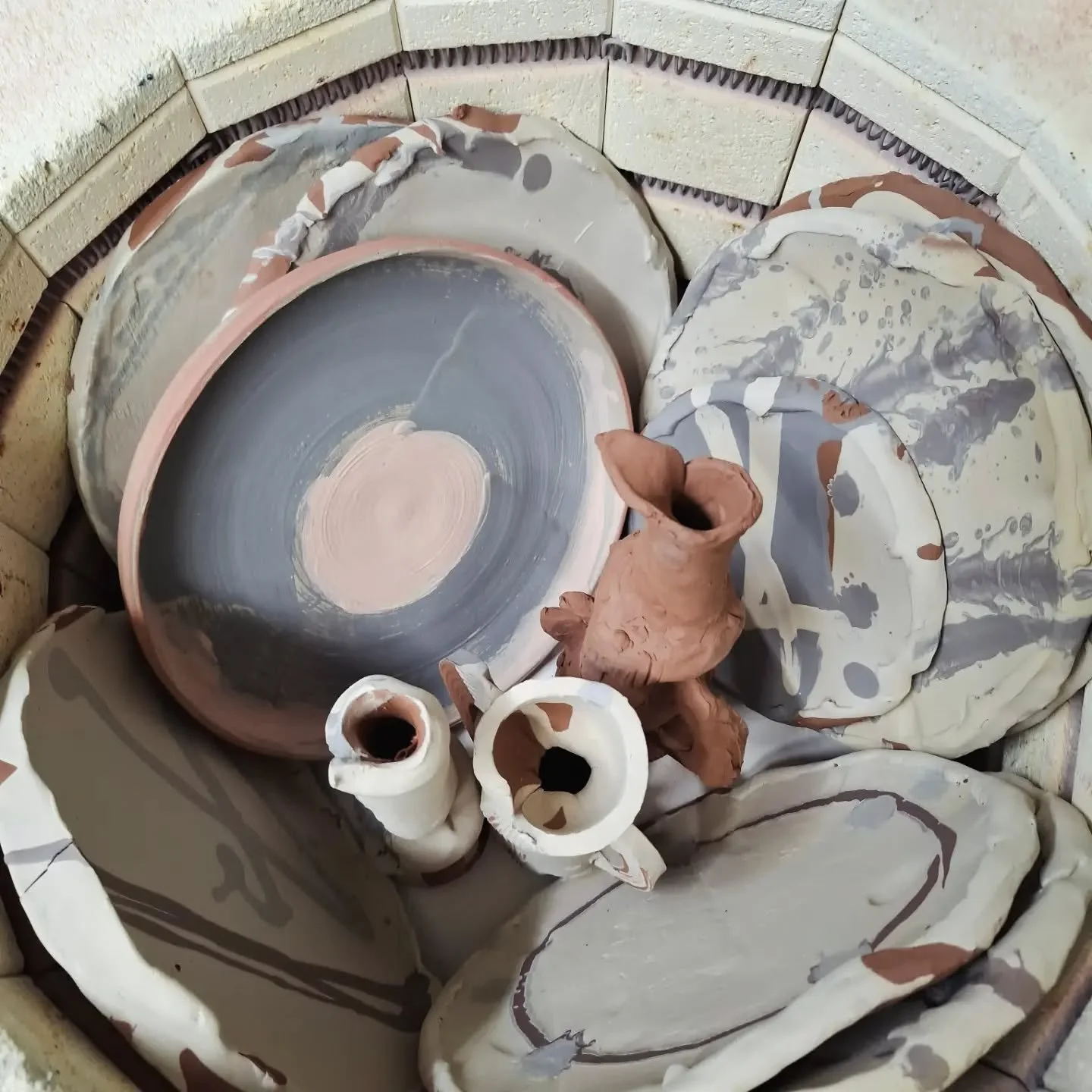 Bisque fire kiln load. Yes those are plates stacked on their sides. Its more efficient use of space and the plates are just fine as long as they don't have thin rims. 

#stleonardsceramics 
#ceramics