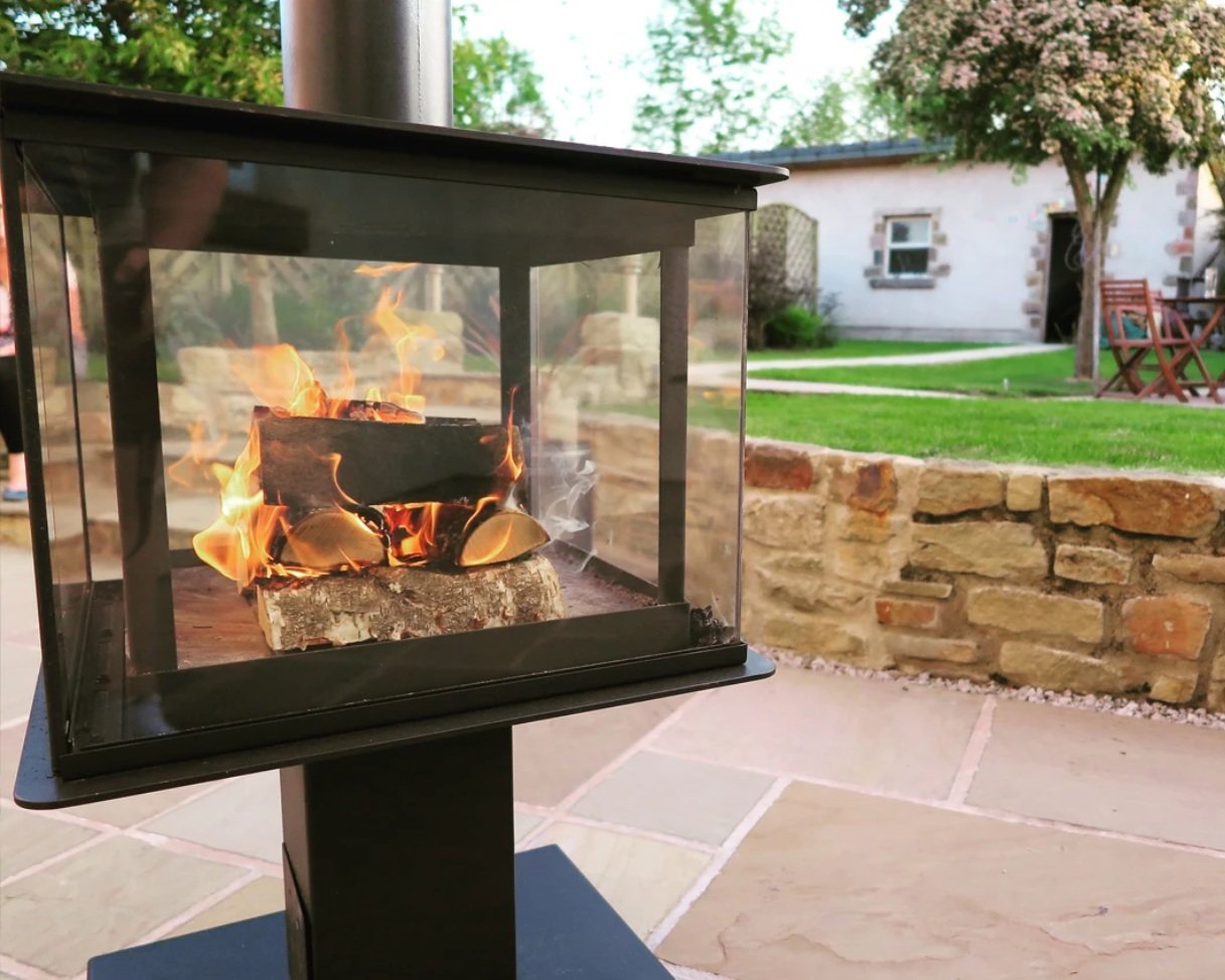 The Garden Cube Wood Burning Heater on an outside patio