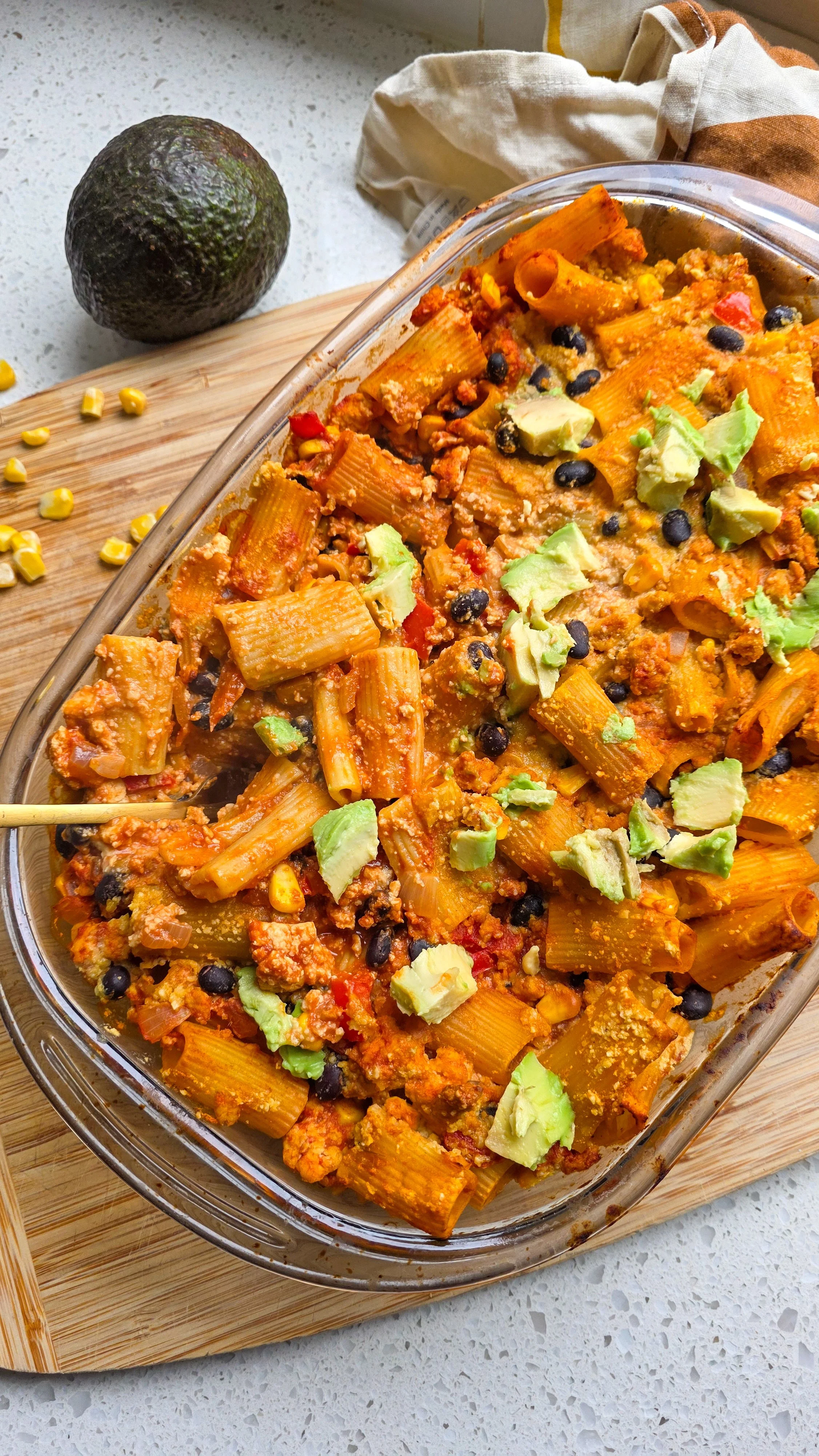 Mexican pasta bake dish with avocado and corn