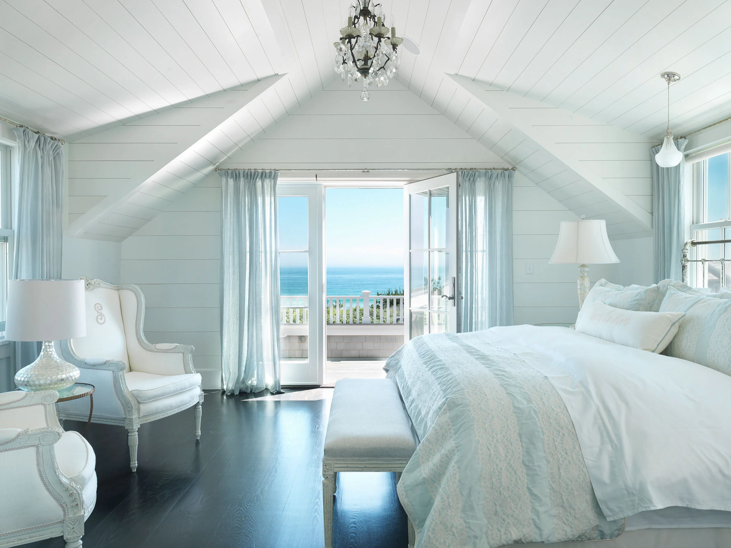 Master Bedroom with Chandelier, French Doors, and Ocean Views in Nantucket Home