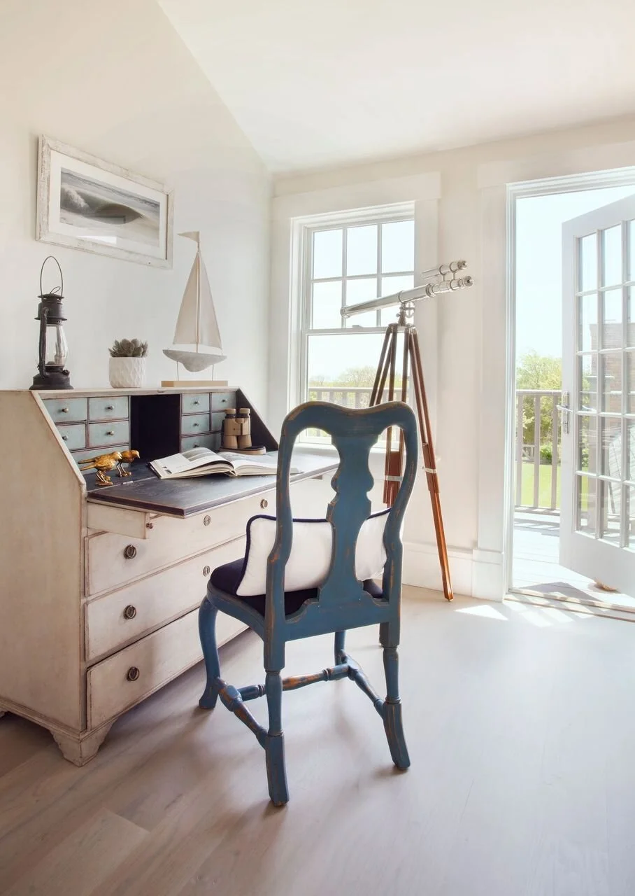 Antique White Desk  and Antique Blue Chair Next to an Antique Telescope in Nantucket Home