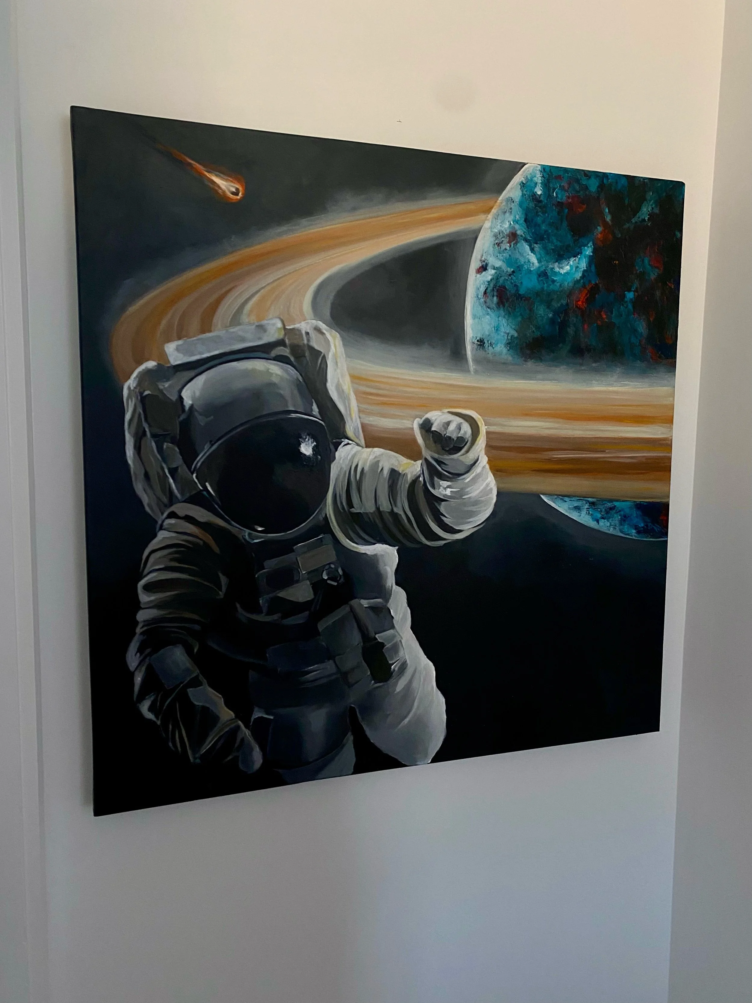 Painting of an astronaut in space with planets and a comet in the background.