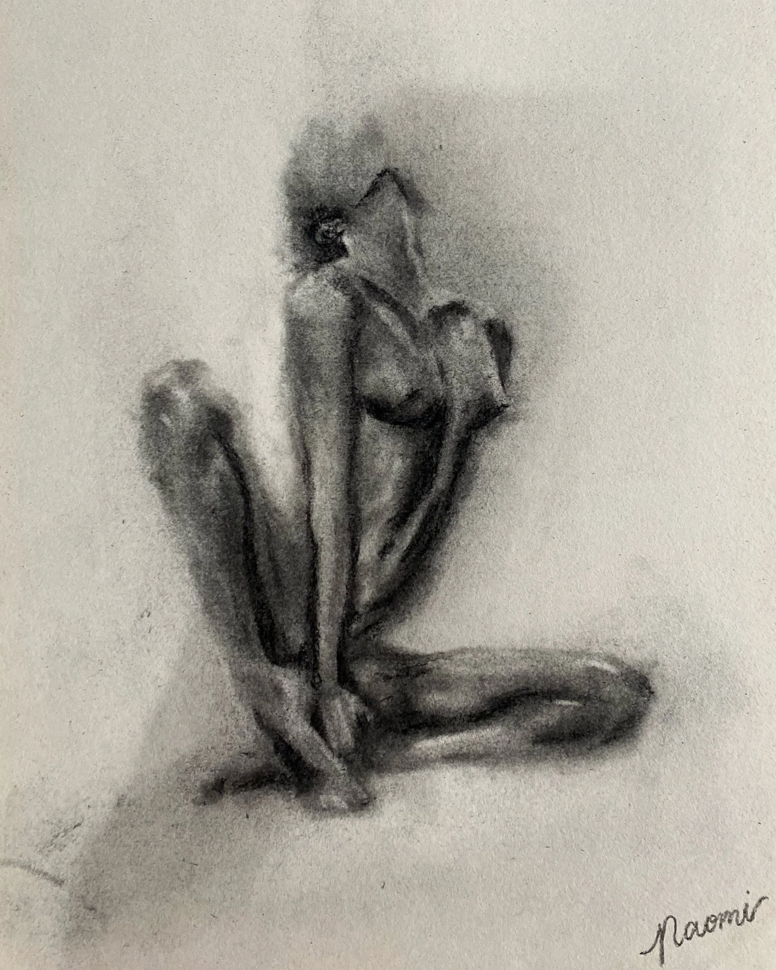 A black and white sketch of a woman sitting on the ground, her head tilted back, with her arms wrapped around her knees. The sketch is signed by Naomi.