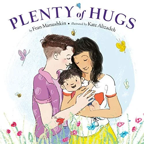 Two mothers hug their baby in a field of flowers with butterflies flying around them