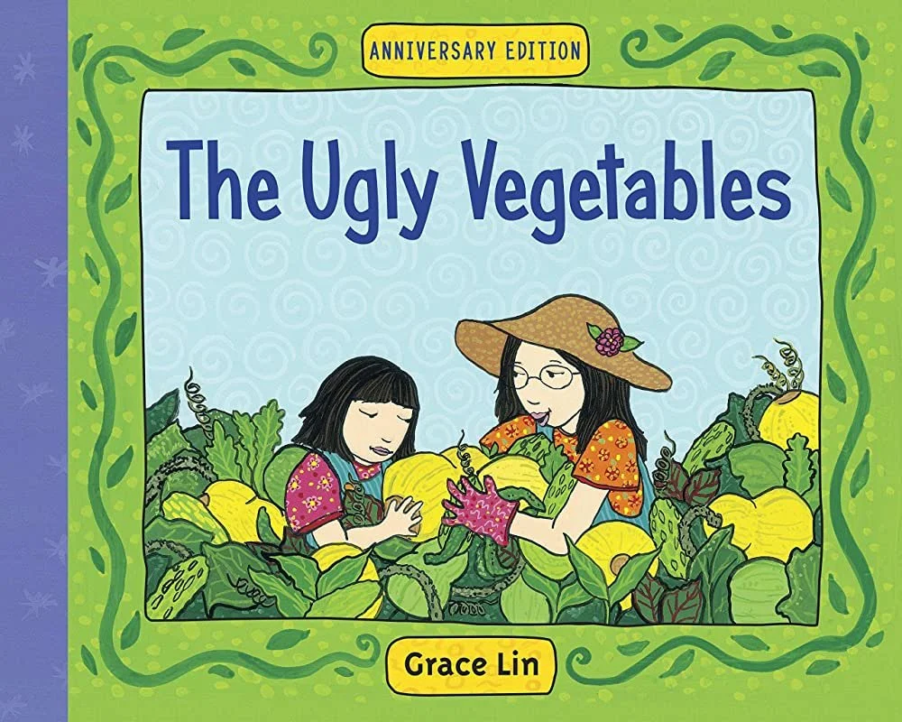 A Chinese mother and daughter sit in a vegetable garden filled with Chinese vegetables surrounded by a green border with vines.