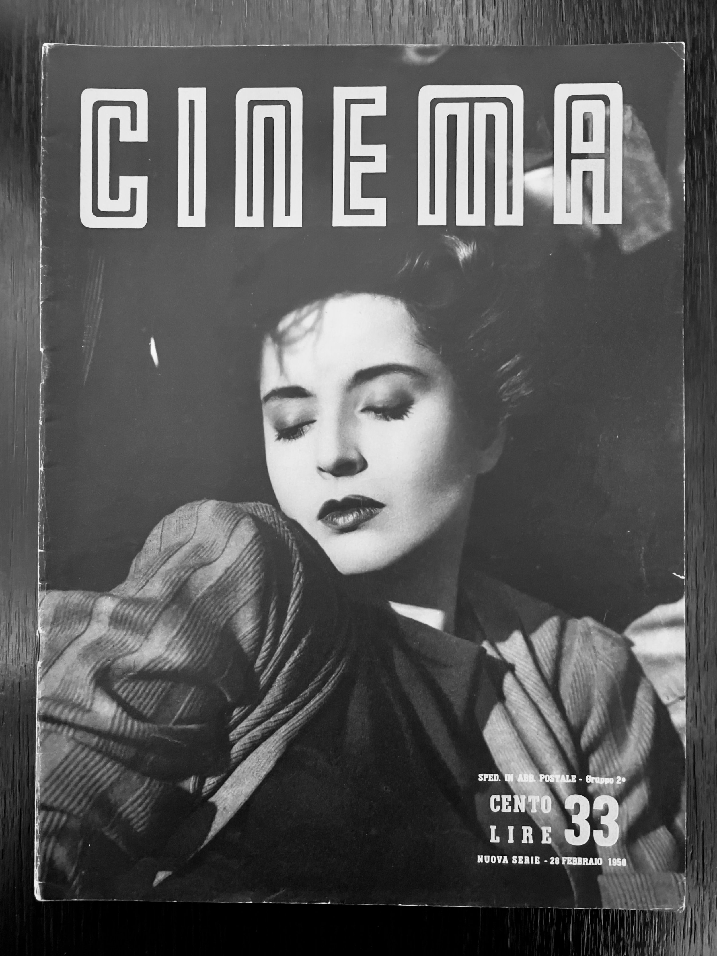 Black and white photograph of a vintage magazine cover with a woman closed eyes and hair styled in waves, wearing a striped shirt. Text indicates it is an Italian magazine from February 28, 1950, priced at 33 lire.