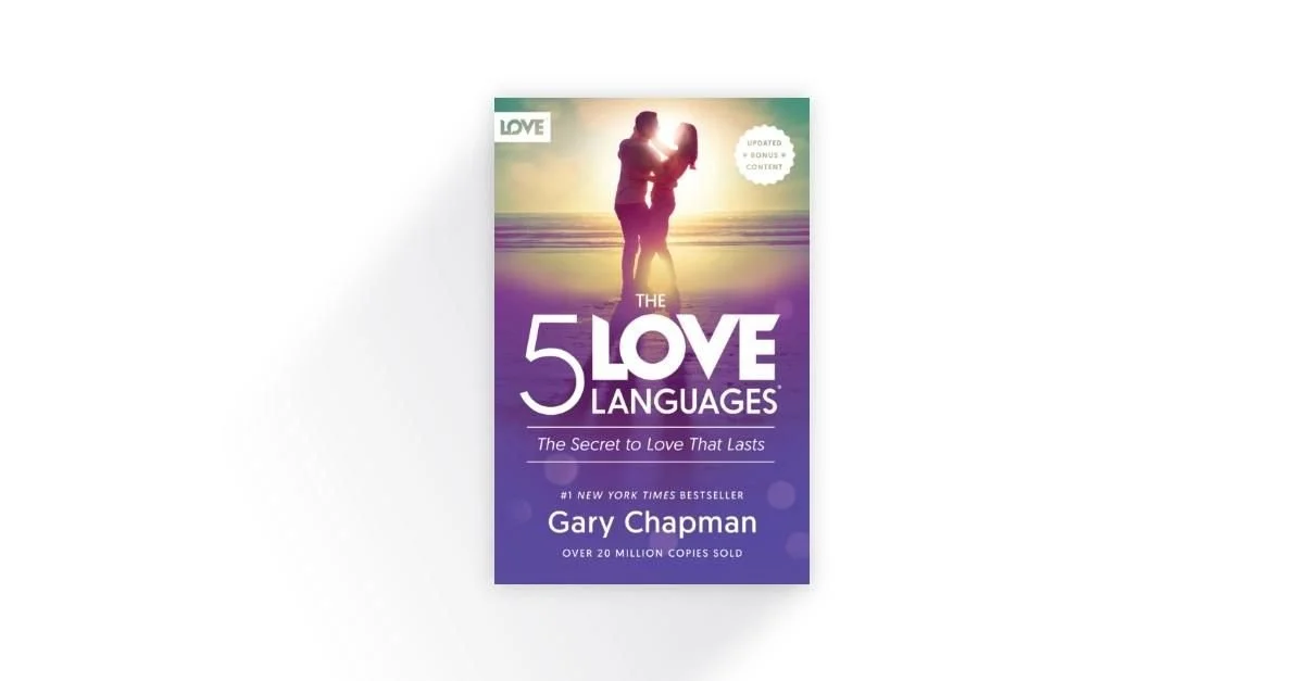 Cover of the book "The 5 Love Languages" by Gary Chapman, featuring a couple embracing at sunset with a purple gradient background.