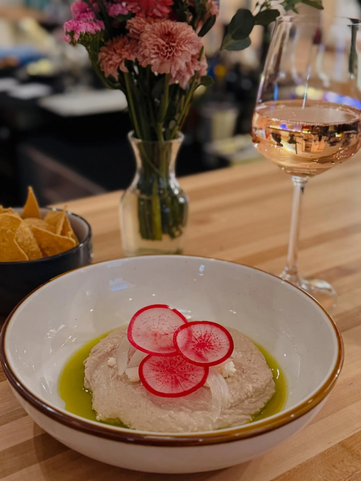 Our pinto hummus is a guest favorite! Made from @teparybeans, pickled onions, radish, queso fresco, and served with tortilla chips. Come in and try some for yourself!! 
#TucsonWineBar #DrinkLocalTucson #SupportLocalAZ #TucsonEatsAndDrinks #AZWineSce