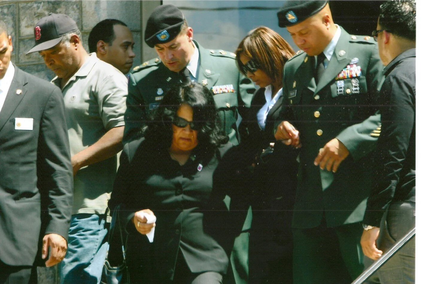 Major Drew Techner (center) assists the widow and mother of Army Sergeant Alex Jiminez during his funeral in Lawrence, Massachusetts.