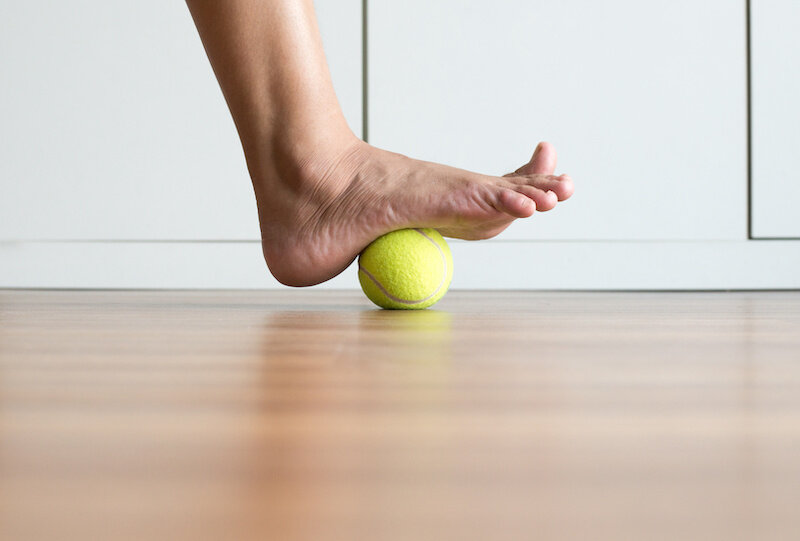 The Most Ignored Part Of Your Body… That Is Killing Your Fitness 3 Tennis-Ball-Foot-Massage.jpeg