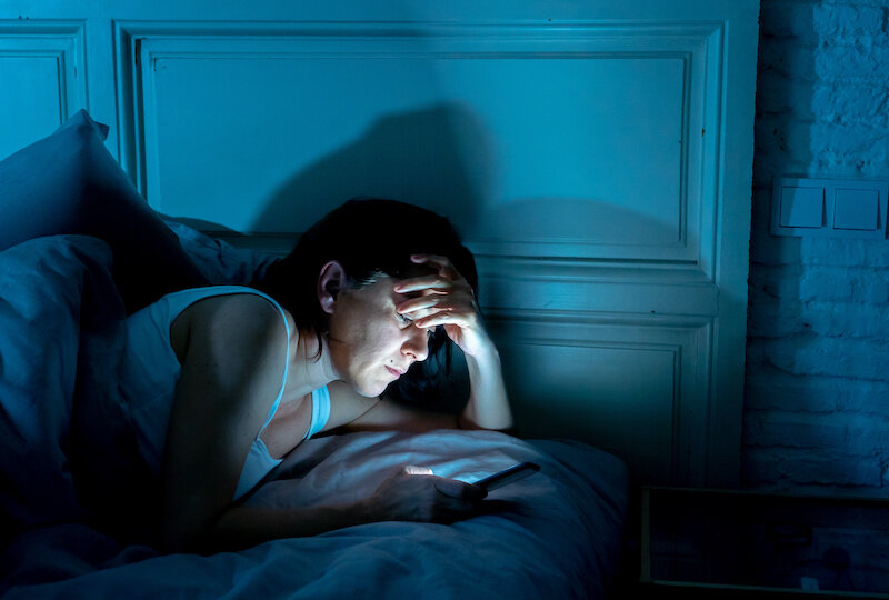 Read This If You Get Less Than 7 Hours Of Sleep Each Night 1 Woman On Phone In Bed.jpeg