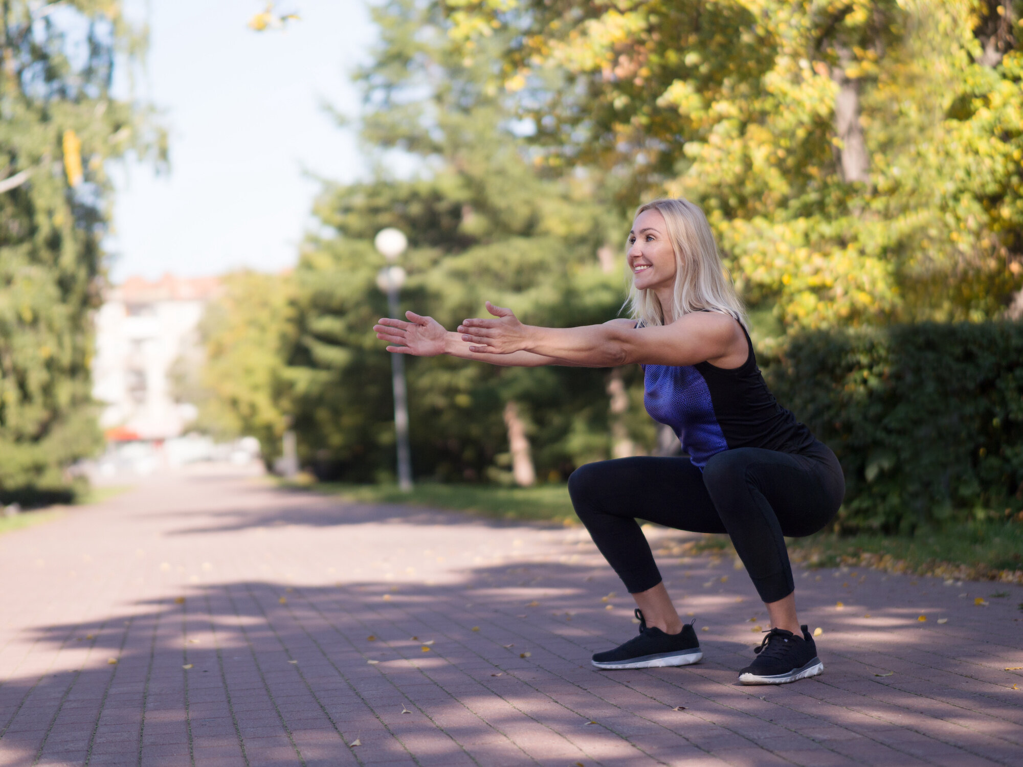 4 Women Share The Top 2 Ways They Took Charge Of Their Stress 2 Woman Squatting Outdoor Workout.jpeg