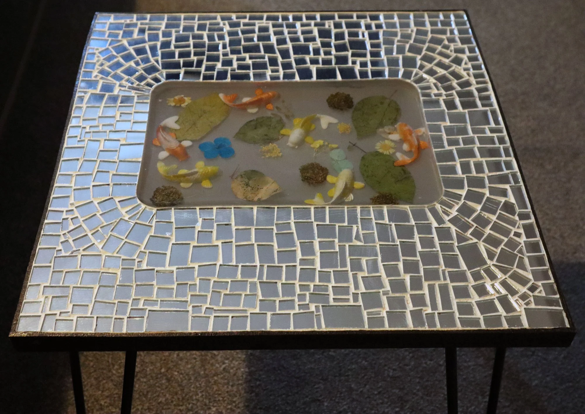 Coi pond in resin set into a mosaic mirror table top
