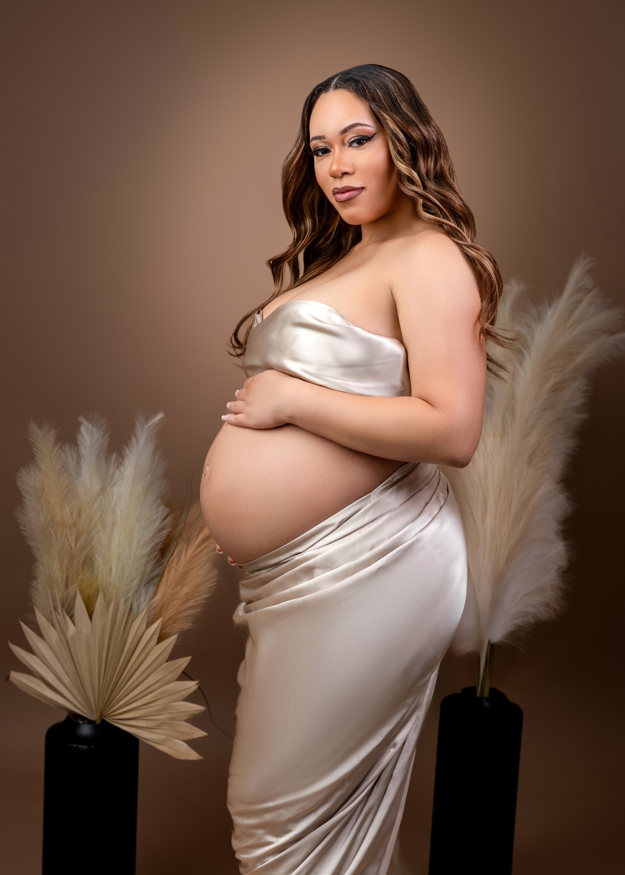 maternity photo of mom to be in a satin fabric dress