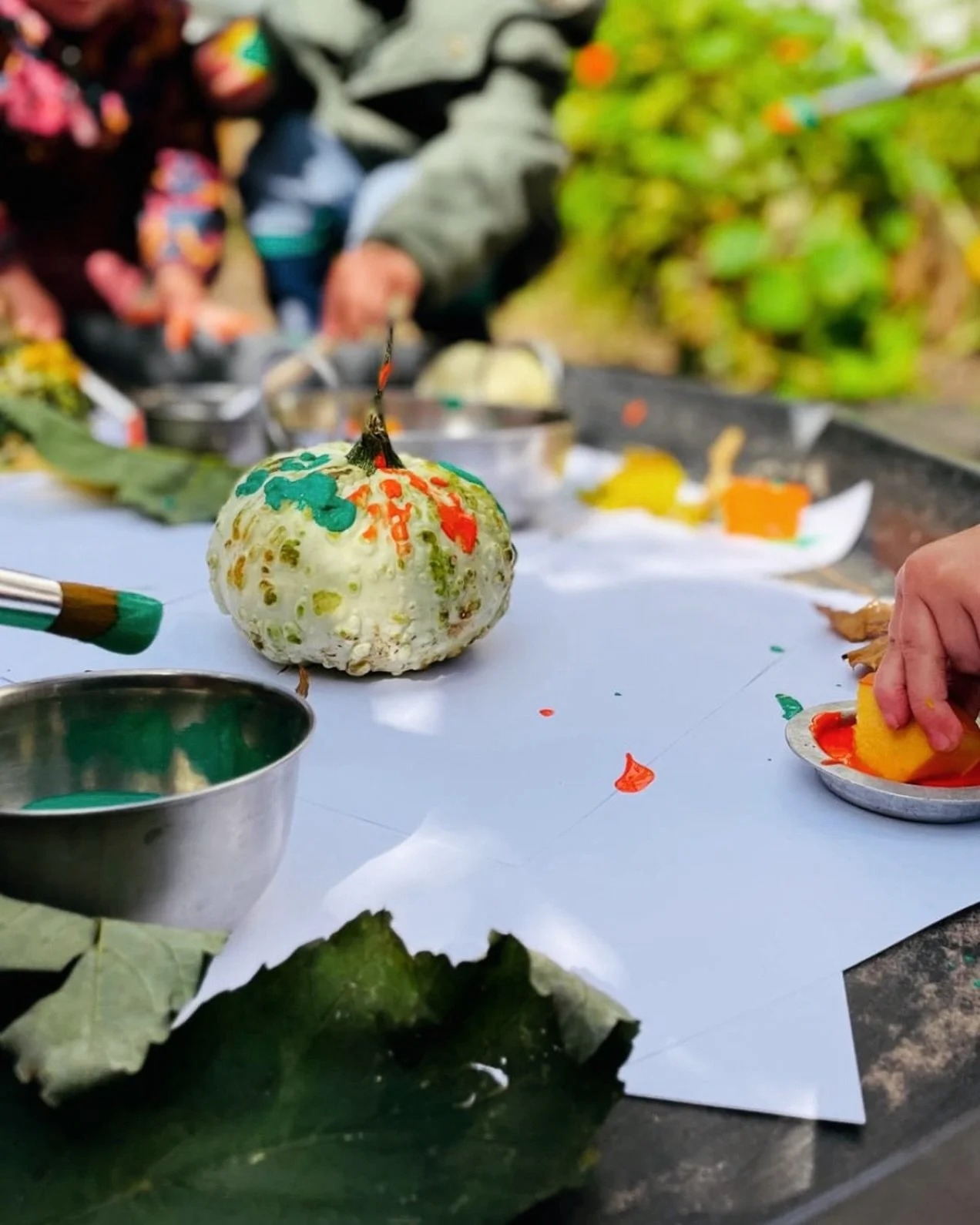 Painting gourds in the garden at Naturally Learning Nansledan 🍂
Our babies are learning from the world around them! 
#thisisnaturallylearning