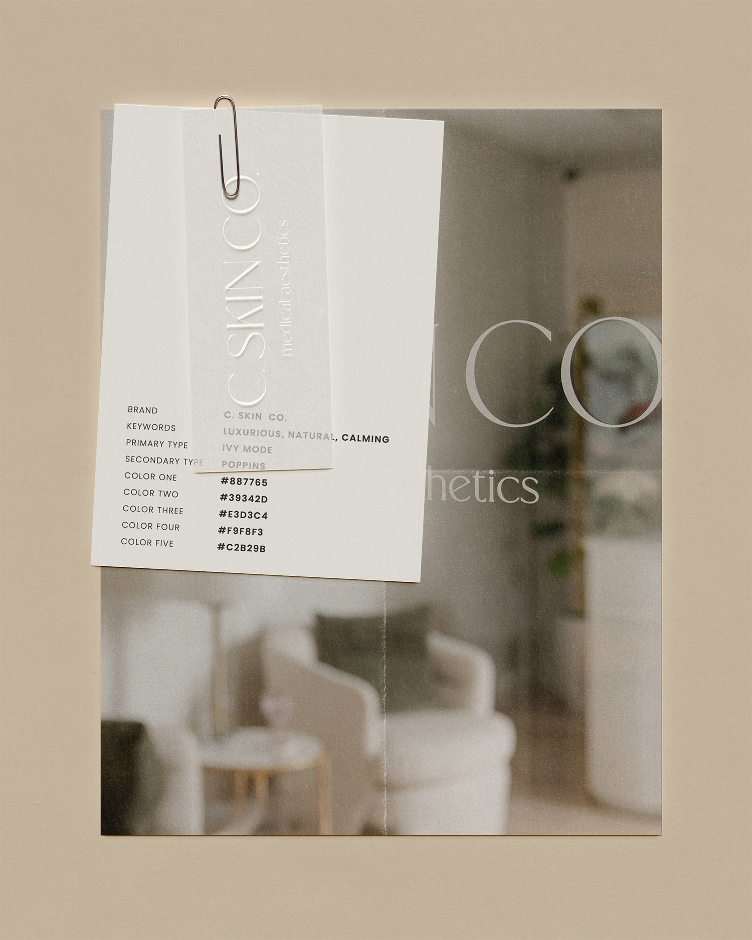 Close-up of a skincare product label attached with a paperclip, with blurred background of a living room or office space.