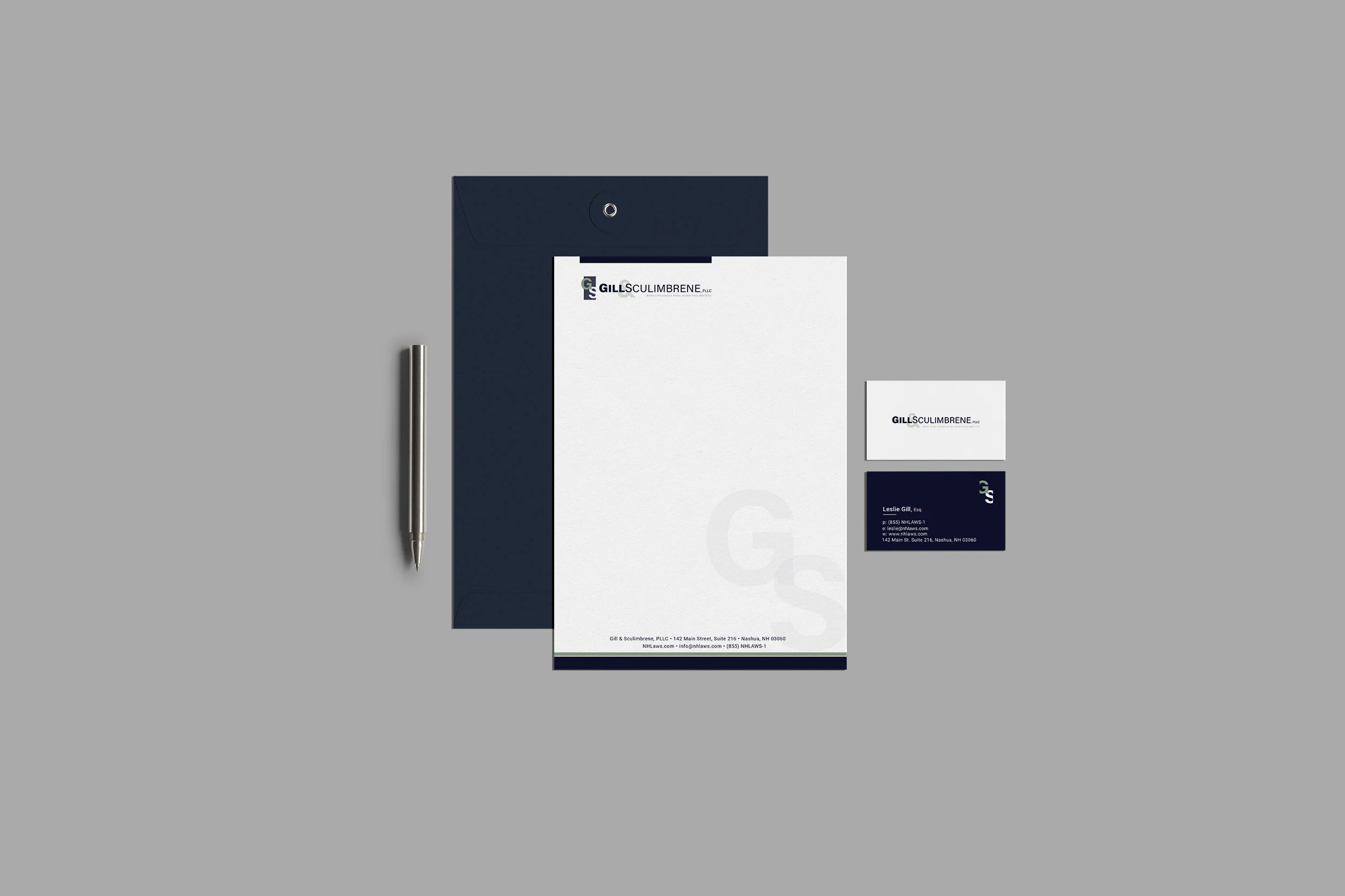 Corporate stationery set with letterhead, business cards, envelope, and pen on a gray background.