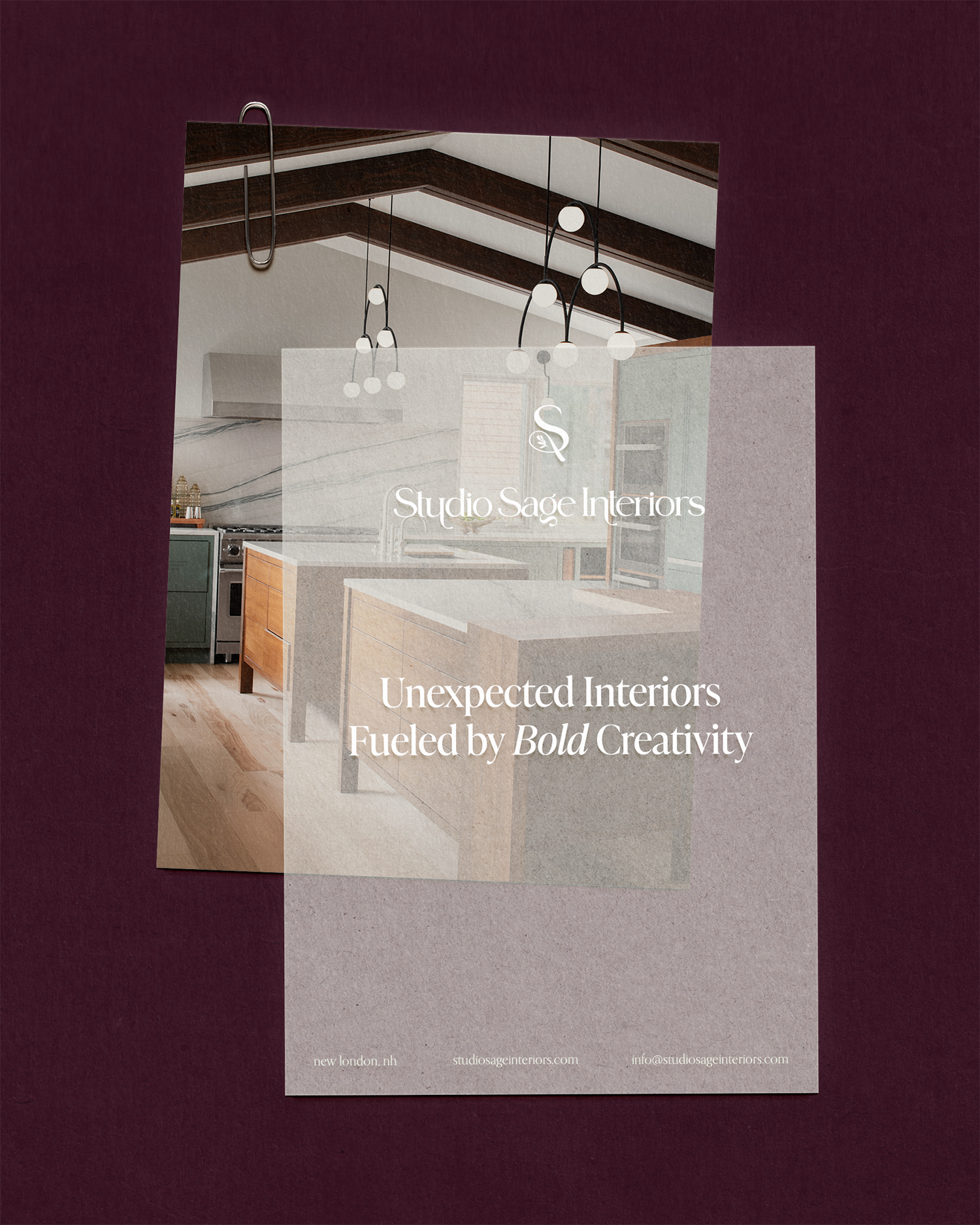 A promotional flyer for Studio Sage Interiors features a partial interior view of a modern kitchen with hanging light fixtures, wooden cabinets, and a marble backsplash. The background is deep maroon with a raised beige banner displaying the company'