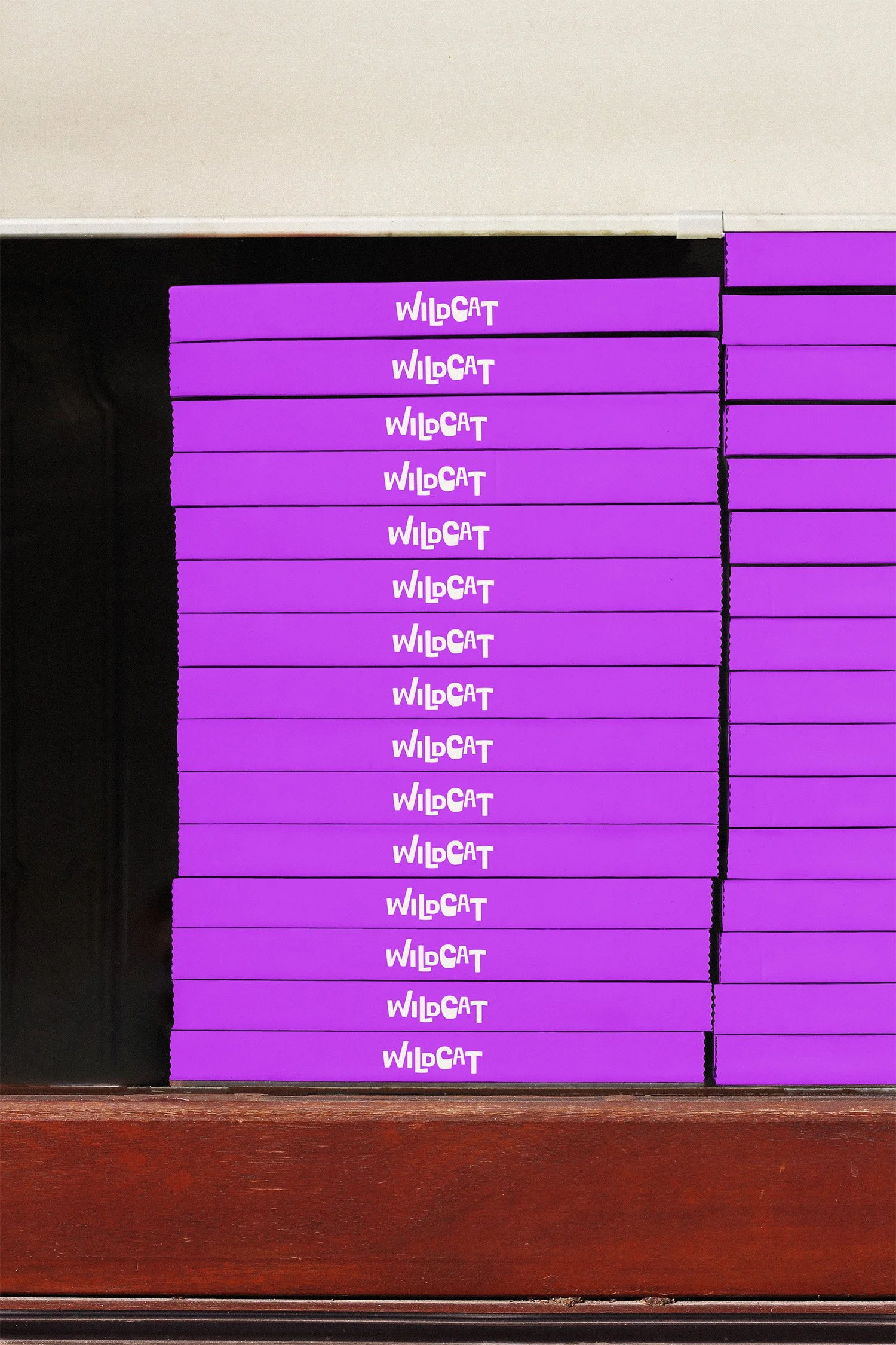 A black velvet box containing multiple purple boxes with the word 'WILDCAT' written in white on each of them.