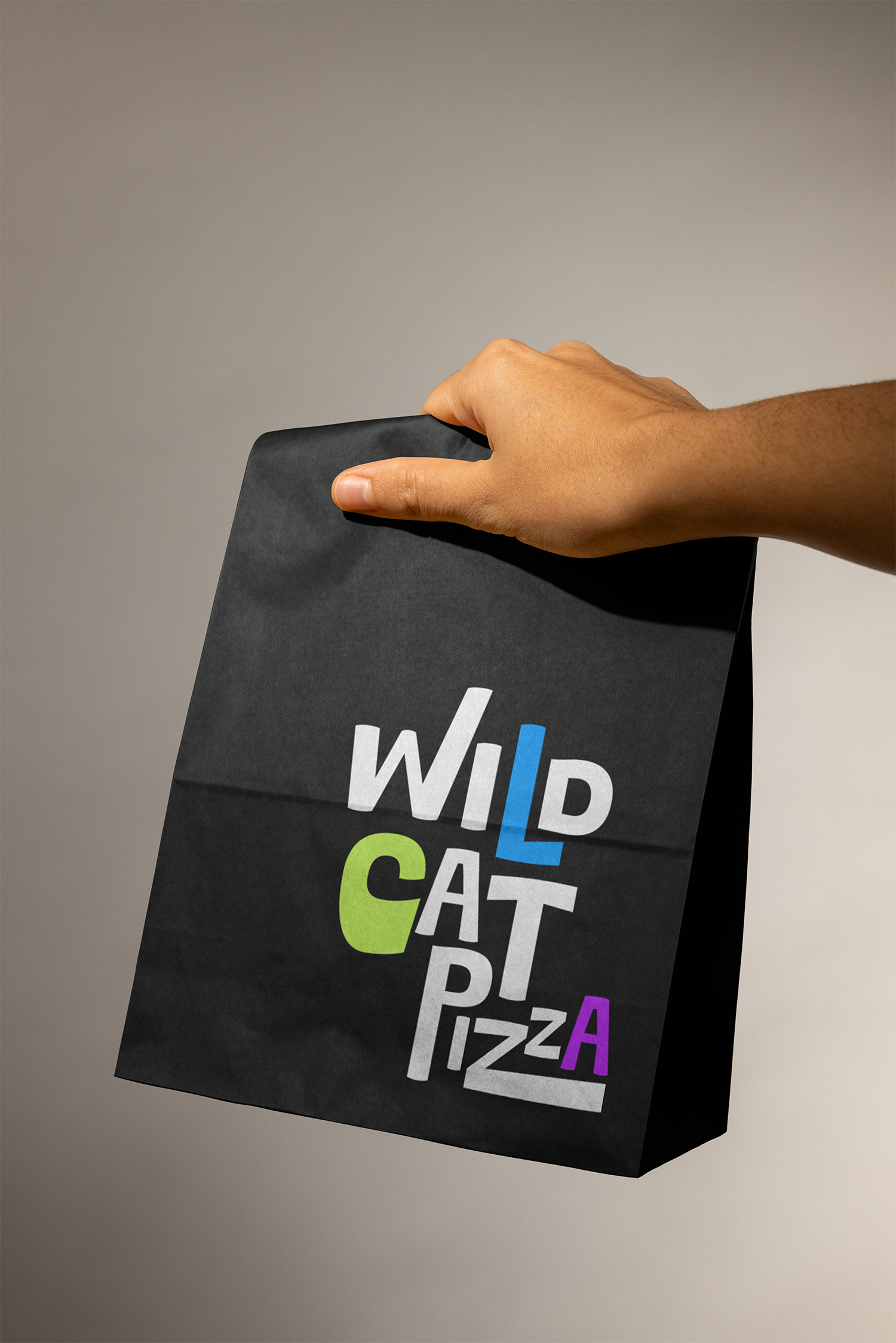 A hand holding a black paper bag with colorful text listing various types of movies, such as 'WILD', 'CART', 'PZZA', and more.