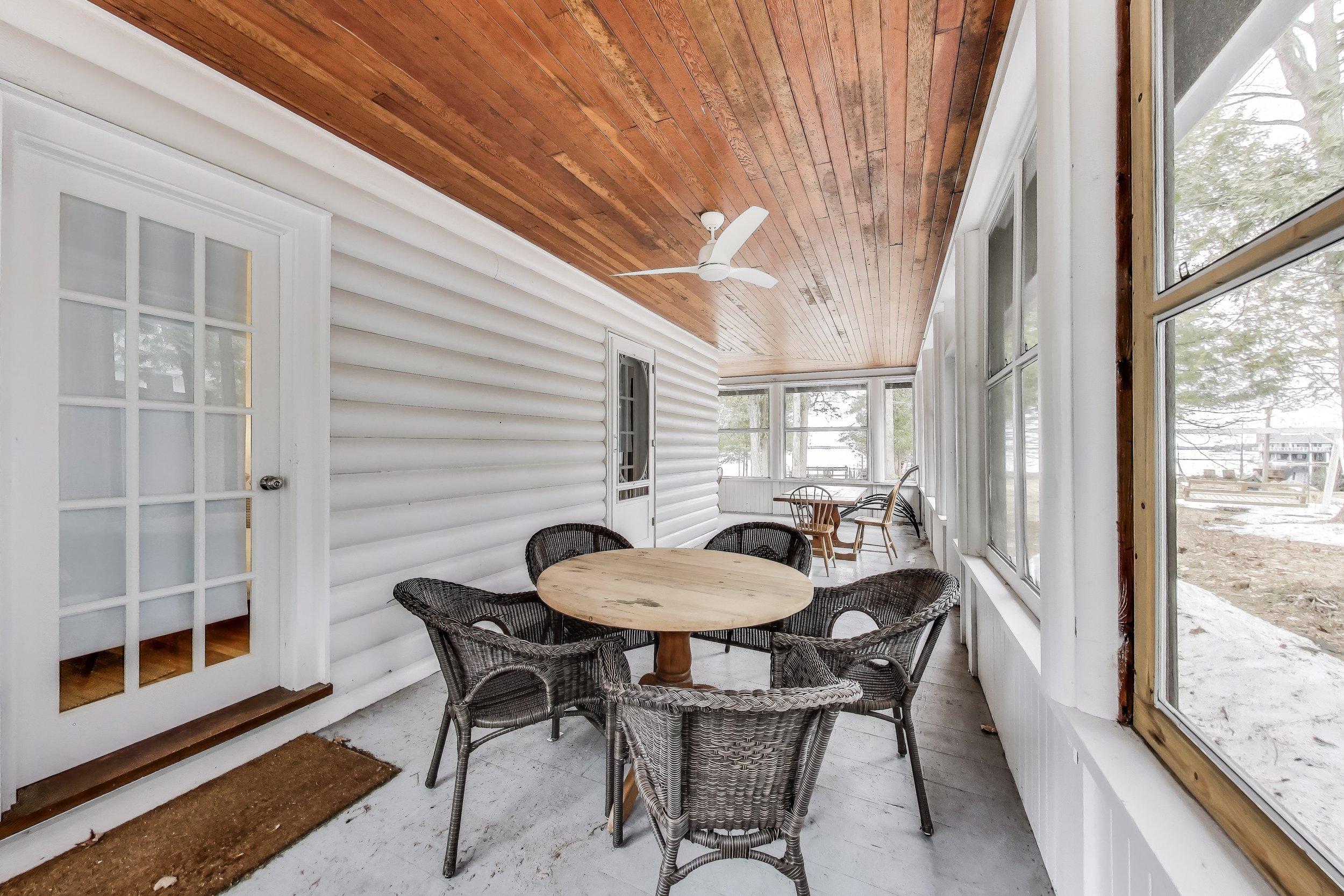 Relaxing covered porch offering a shaded space to unwind and enjoy the outdoors—ideal for sipping coffee, reading, or enjoying the fresh air in Ontario’s cottage country.