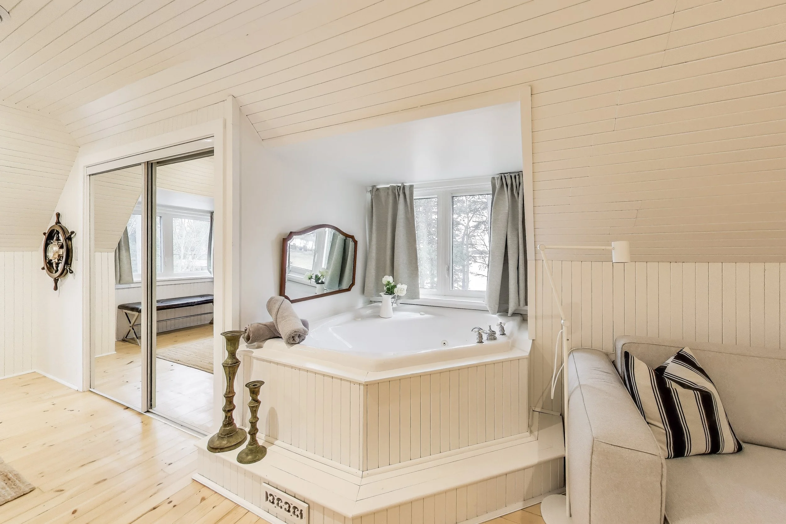 Spacious master bedroom with indoor spa for ultimate relaxation after a day of golf or lakefront activities in Ontario’s cottage country.