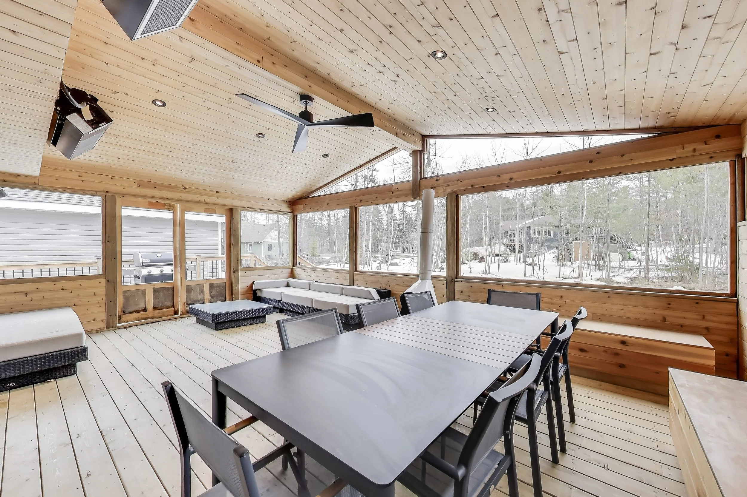 Spacious Muskoka room with comfortable seating, offering the perfect outdoor living space to relax, entertain, and enjoy the natural beauty of Ontario’s cottage country.