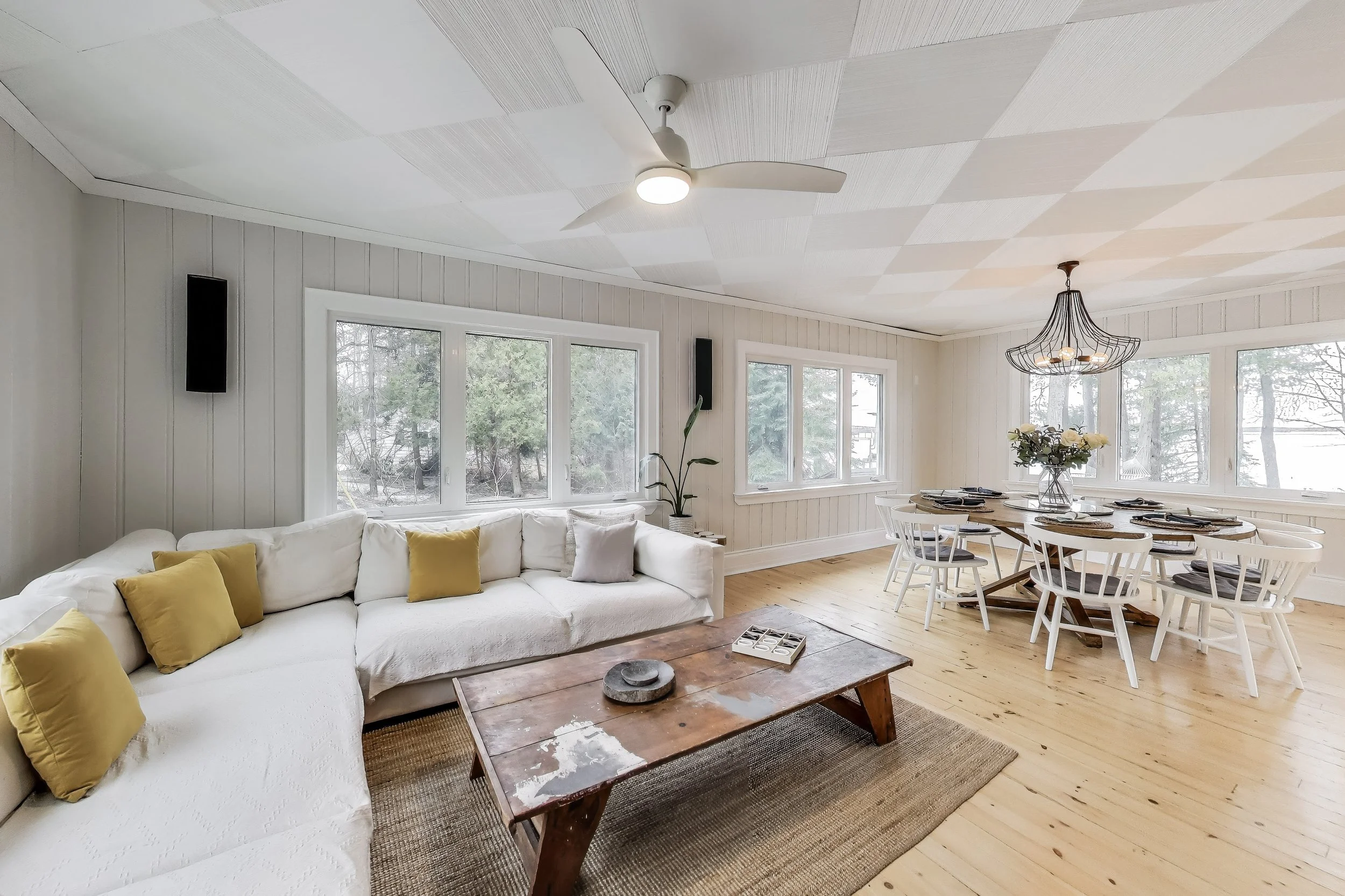 Inviting living room, featuring cozy seating and a modern design—perfect for relaxing after a day of golf, enjoying lakefront views, or unwinding in Ontario's beautiful cottage country.