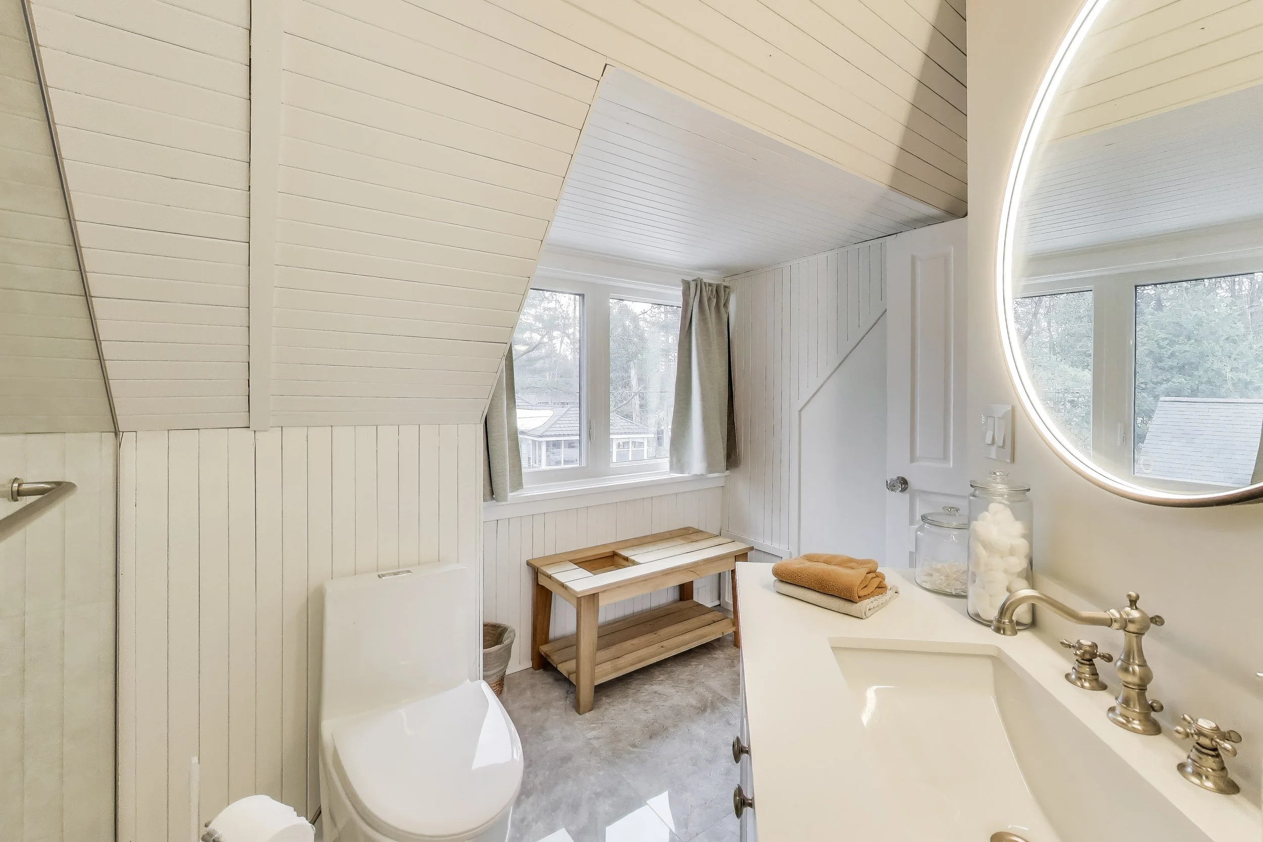 Modern bathroom featuring sleek design and refreshing amenities—perfect for relaxing after a day of golf or enjoying lakefront activities in Ontario’s cottage country.