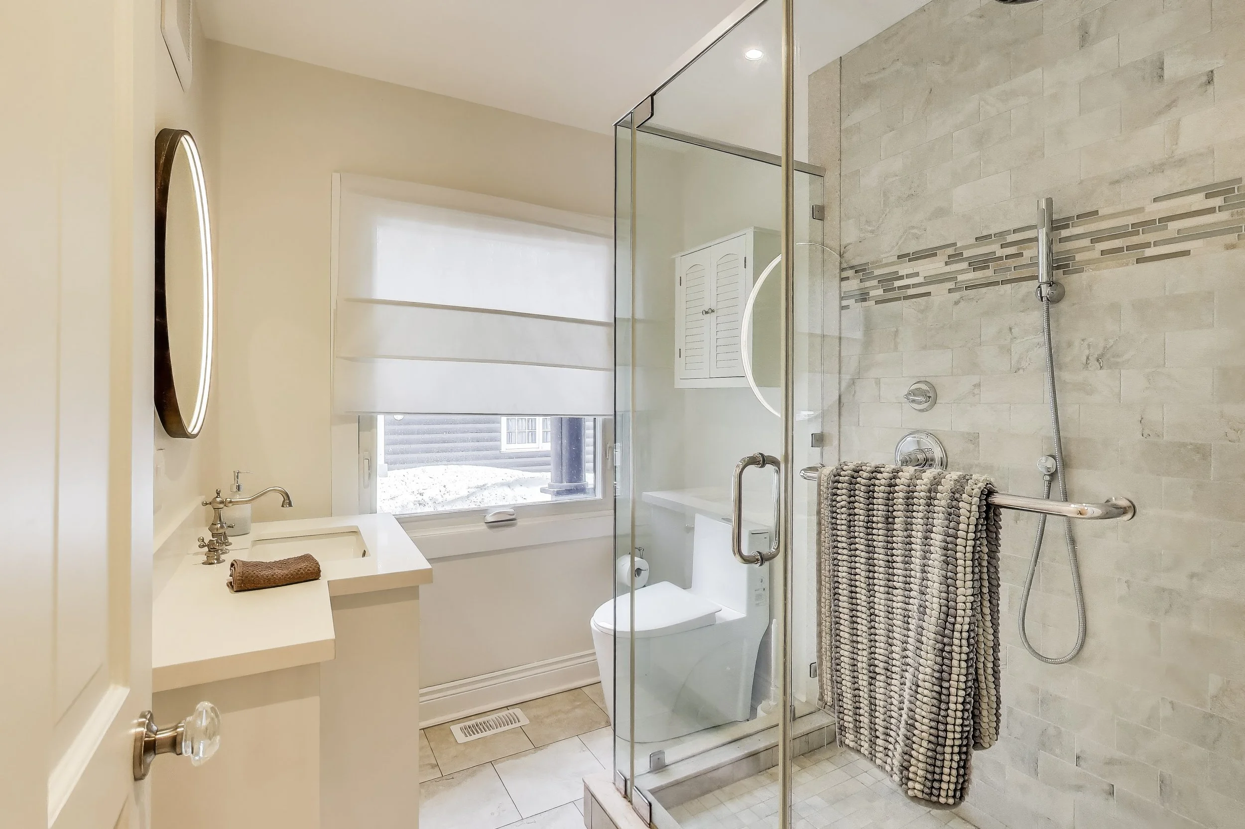 Modern bathroom featuring sleek design and refreshing amenities—perfect for relaxing after a day of golf or enjoying lakefront activities in Ontario’s cottage country.