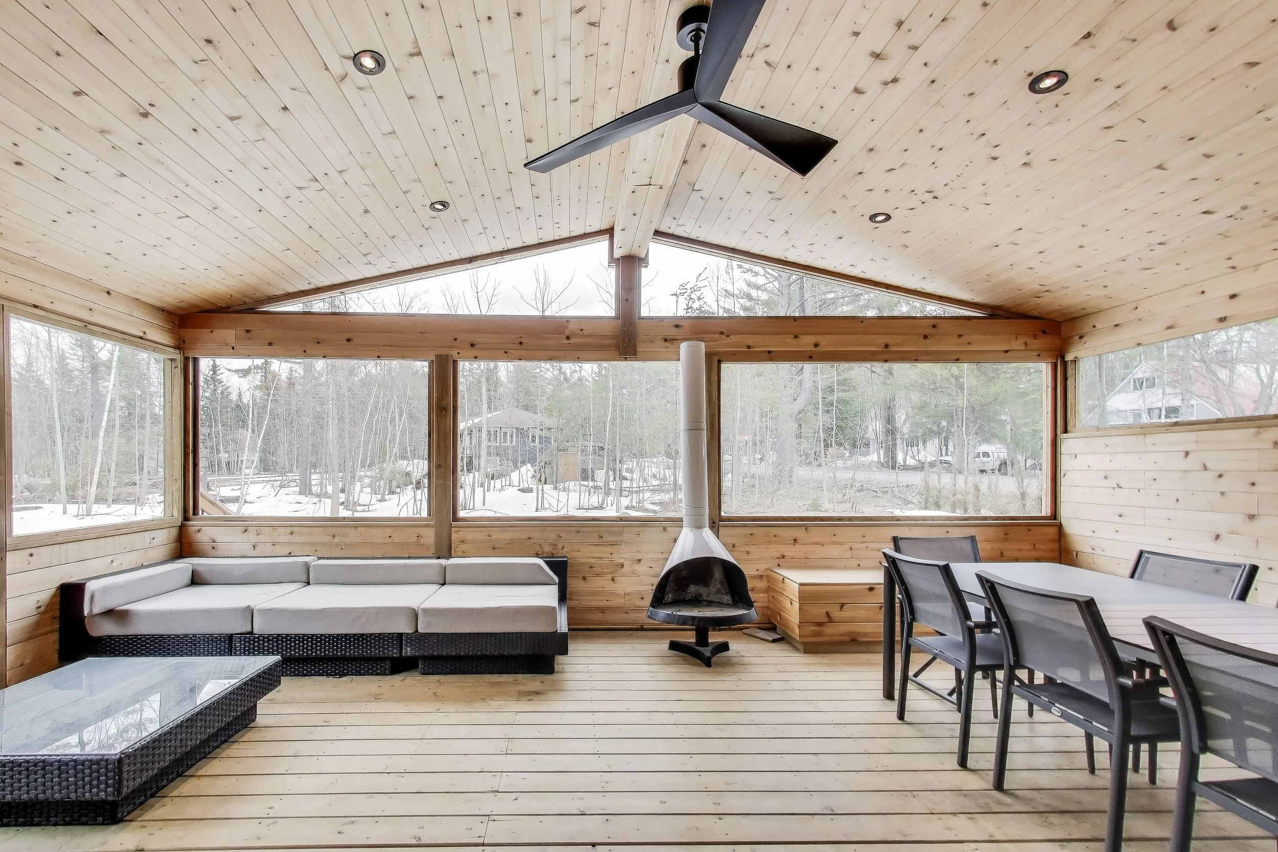 Spacious Muskoka room with comfortable seating, offering the perfect outdoor living space to relax, entertain, and enjoy the natural beauty of Ontario’s cottage country.