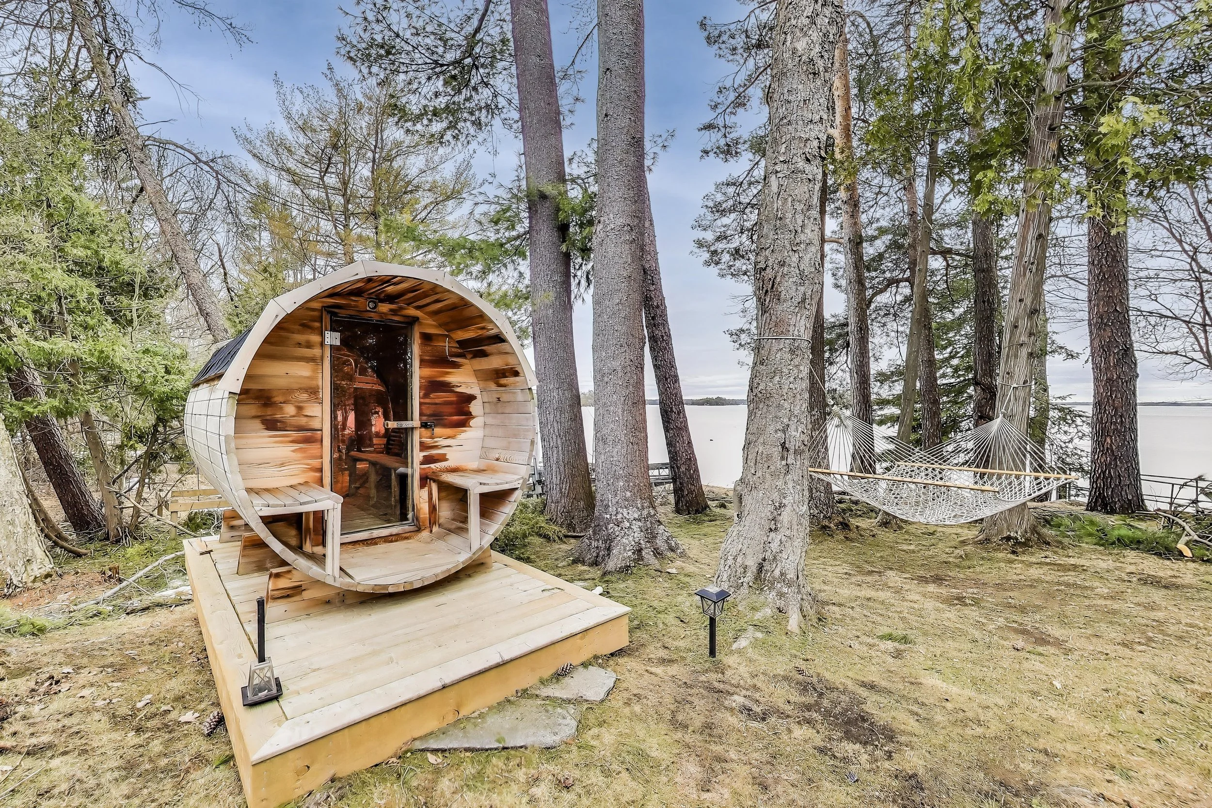 Outdoor sauna with stunning lake views, offering the perfect place to unwind and relax after a day of golf or lakefront activities in Ontario’s cottage country.