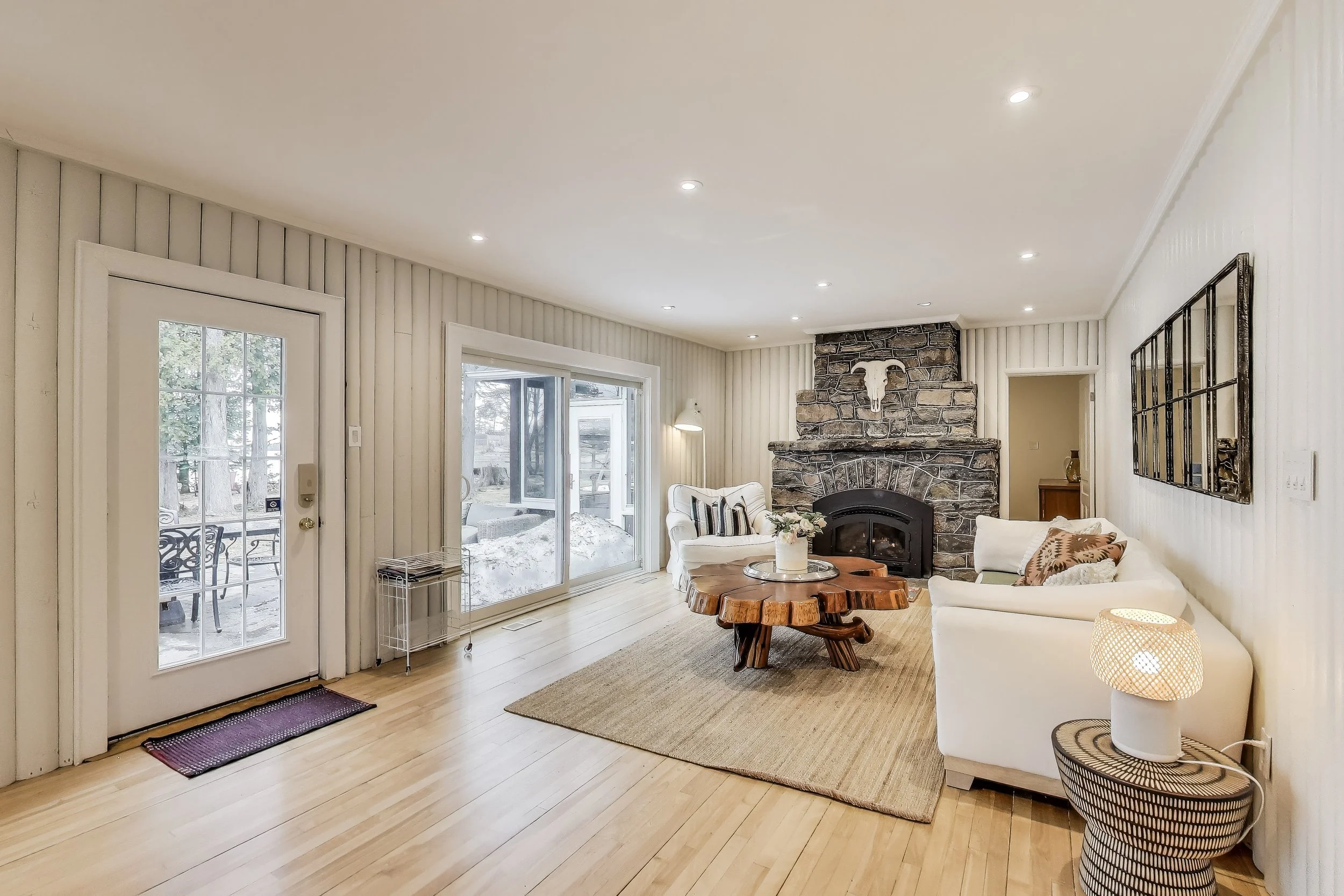 Inviting living room, featuring cozy seating and a modern design—perfect for relaxing after a day of golf, enjoying lakefront views, or unwinding in Ontario's beautiful cottage country.