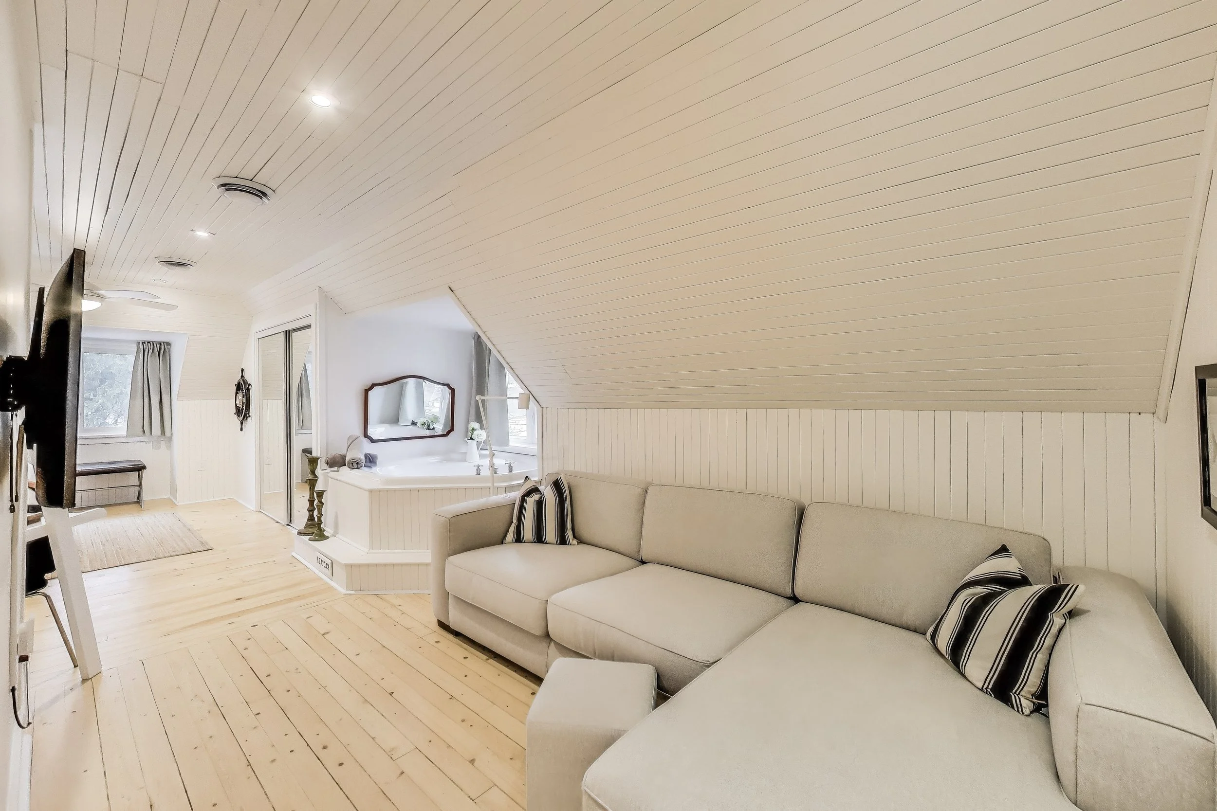 Spacious master bedroom with indoor spa for ultimate relaxation after a day of golf or lakefront activities in Ontario’s cottage country.