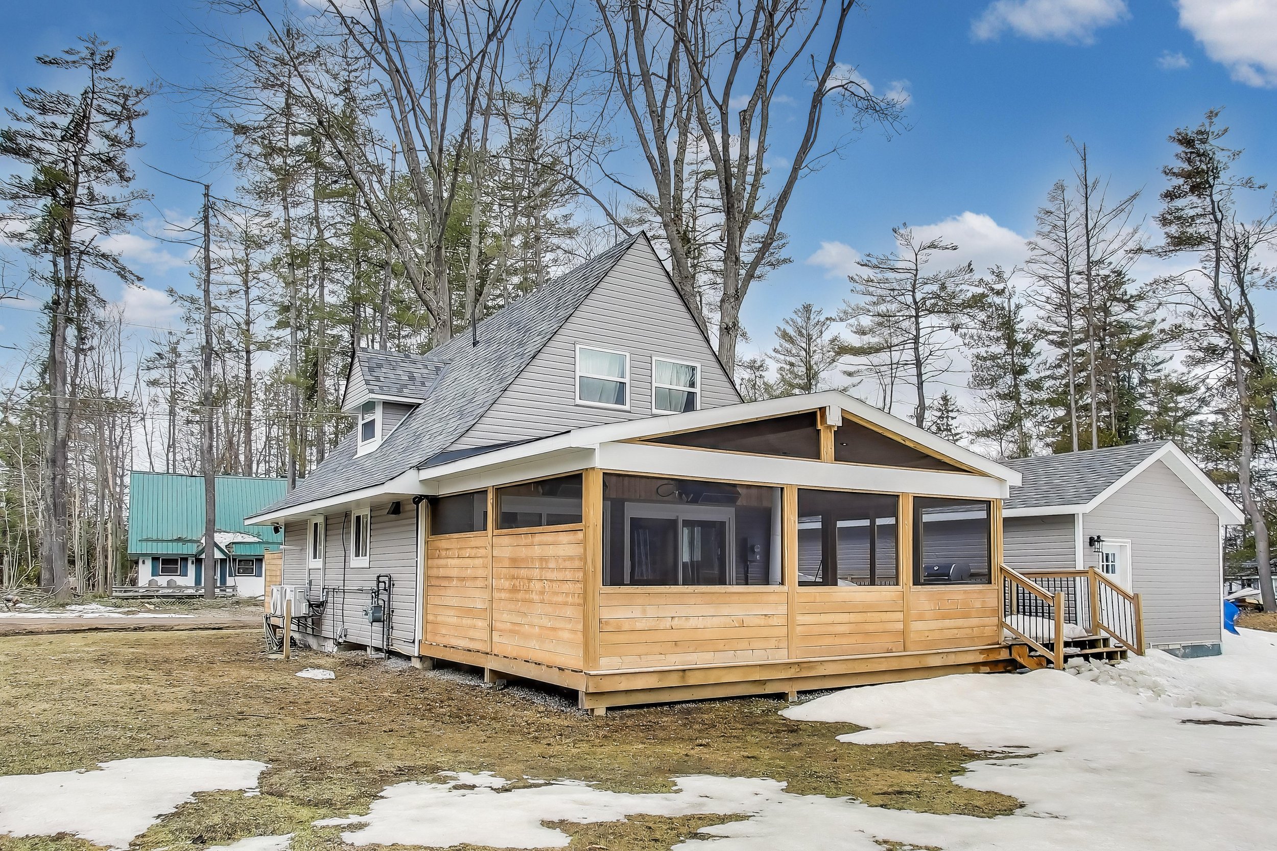 Scenic A-frame cottage in Muskoka, Ontario nestled among trees with shared lake access and a rustic-modern design — perfect for nature lovers, families, or golf getaways in Ontario’s cottage country.