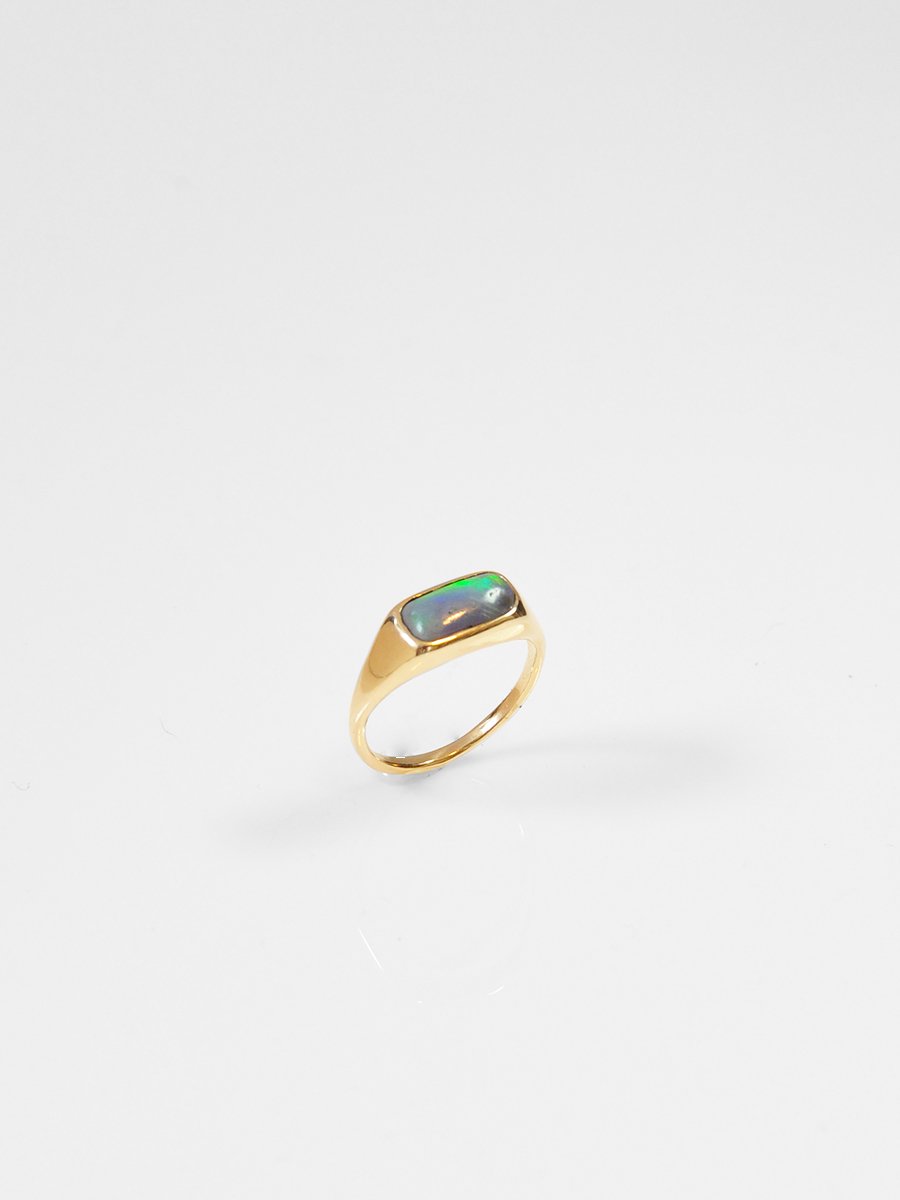 Antique pill-shaped opal cabochon embedded in a 14k yellow gold cocktail ring. Heirloom piece reworked by Shana Tabor.