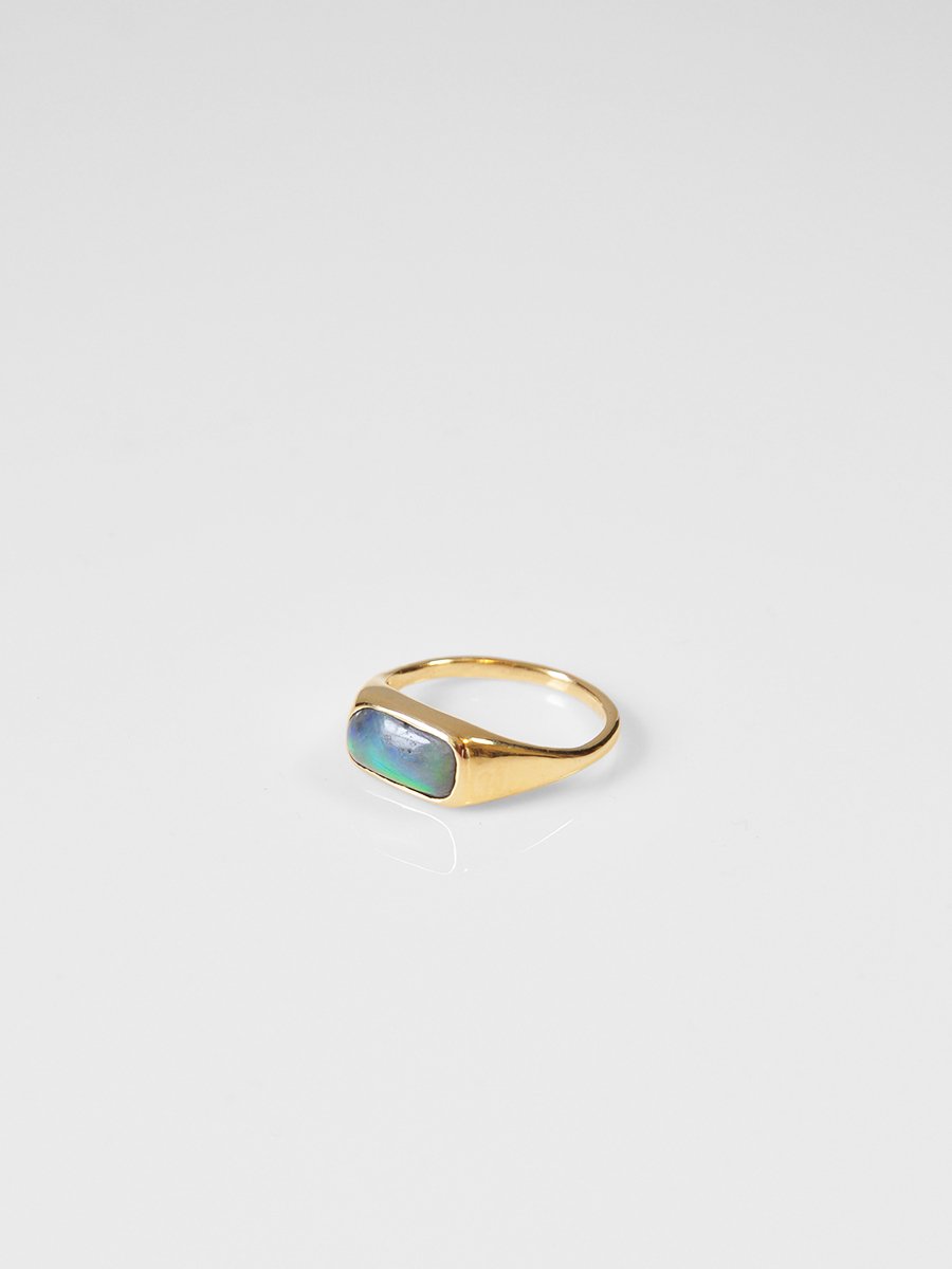 Antique pill-shaped opal cabochon embedded in a 14k yellow gold cocktail ring. Heirloom piece reworked by Shana Tabor.